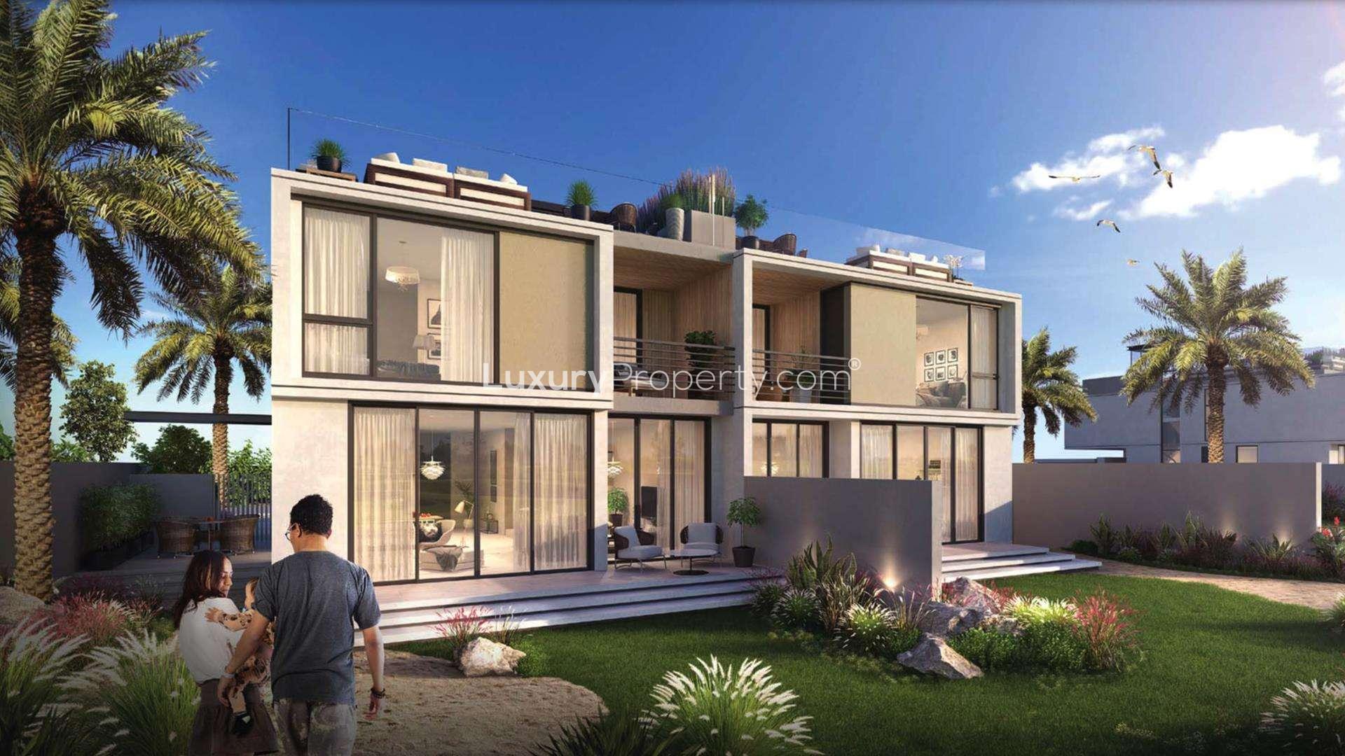 Outdoor pool area at Club Villas, Dubai Hills, featuring families enjoying leisure time together