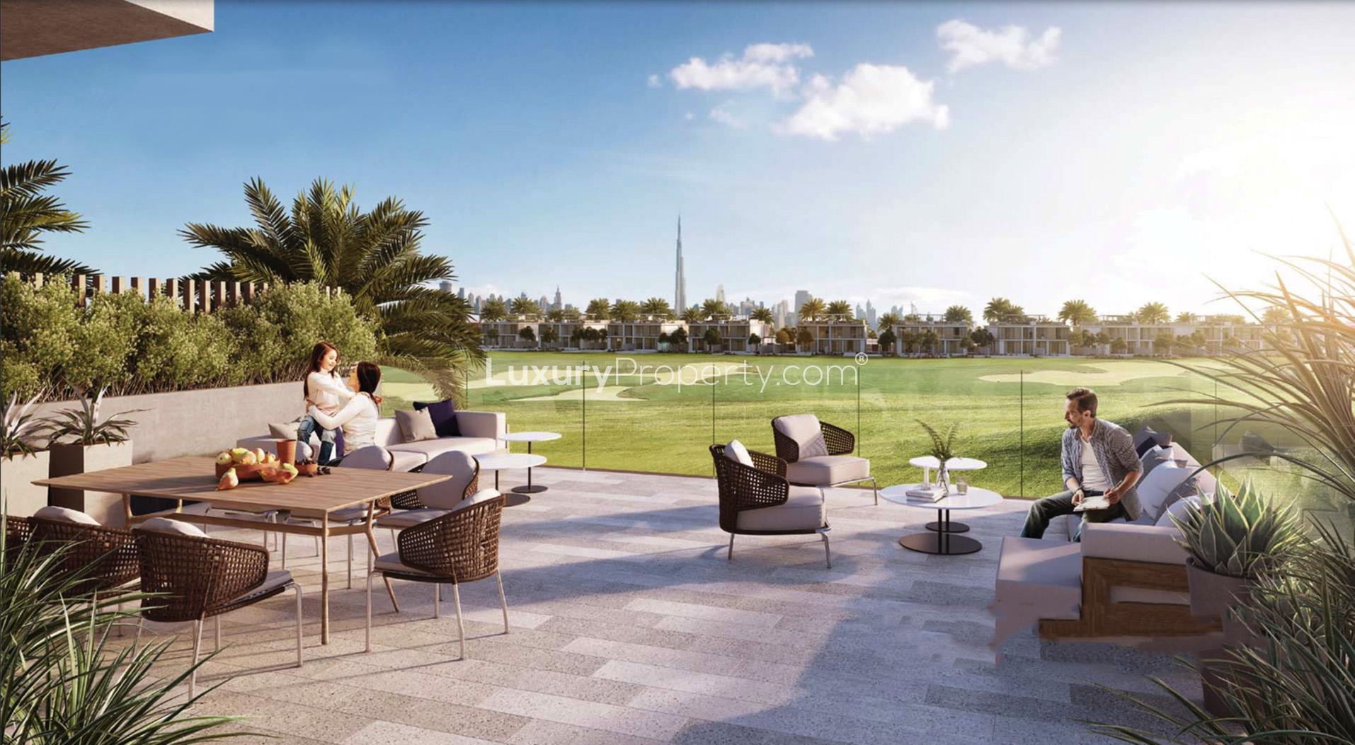 Luxurious villa pool area at Club Villas, Dubai Hills Estate, with families enjoying the amenities