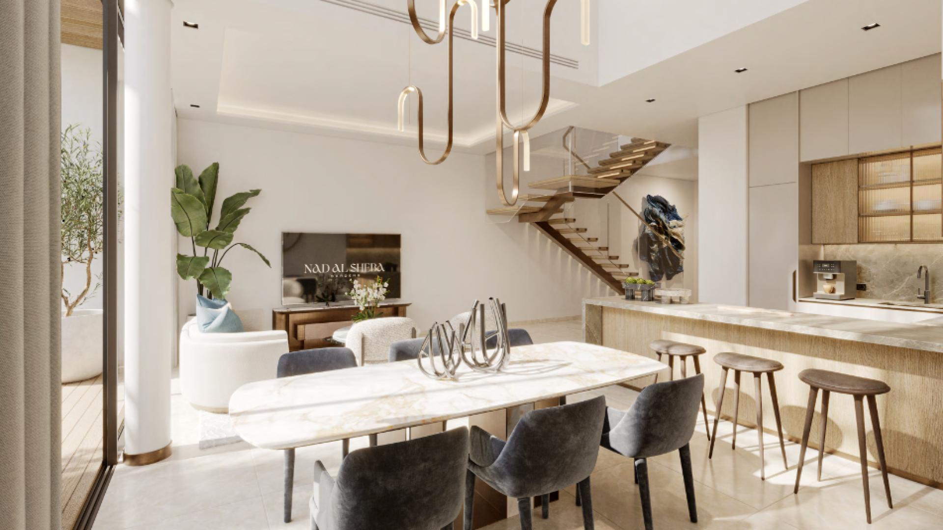 "Spacious modern kitchen and dining area in Nad Al Sheba Gardens townhouse for sale.",Elegant bedroom in Nad Al Sheba townhouse, featuring modern decor and large window view