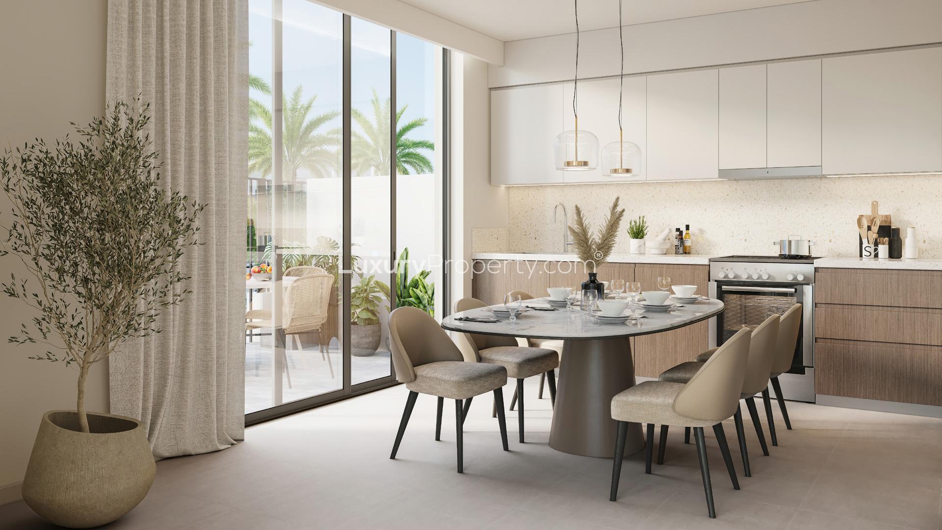 Modern kitchen and dining area in Emaar South villa, Dubai South. Elegant interior design