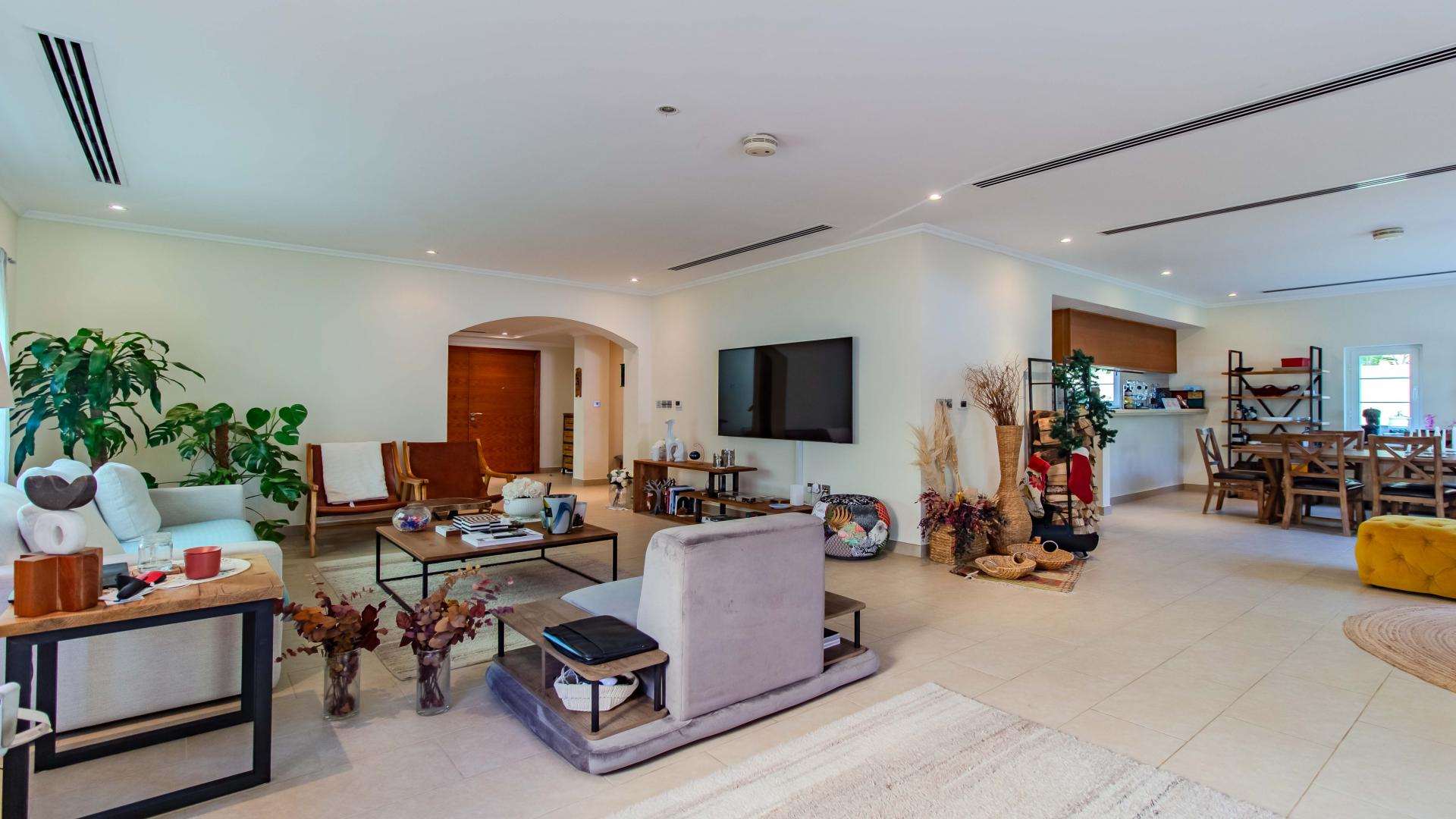 Living room in 3-bedroom Legacy Villa, Jumeirah Park, featuring elegant decor and garden view