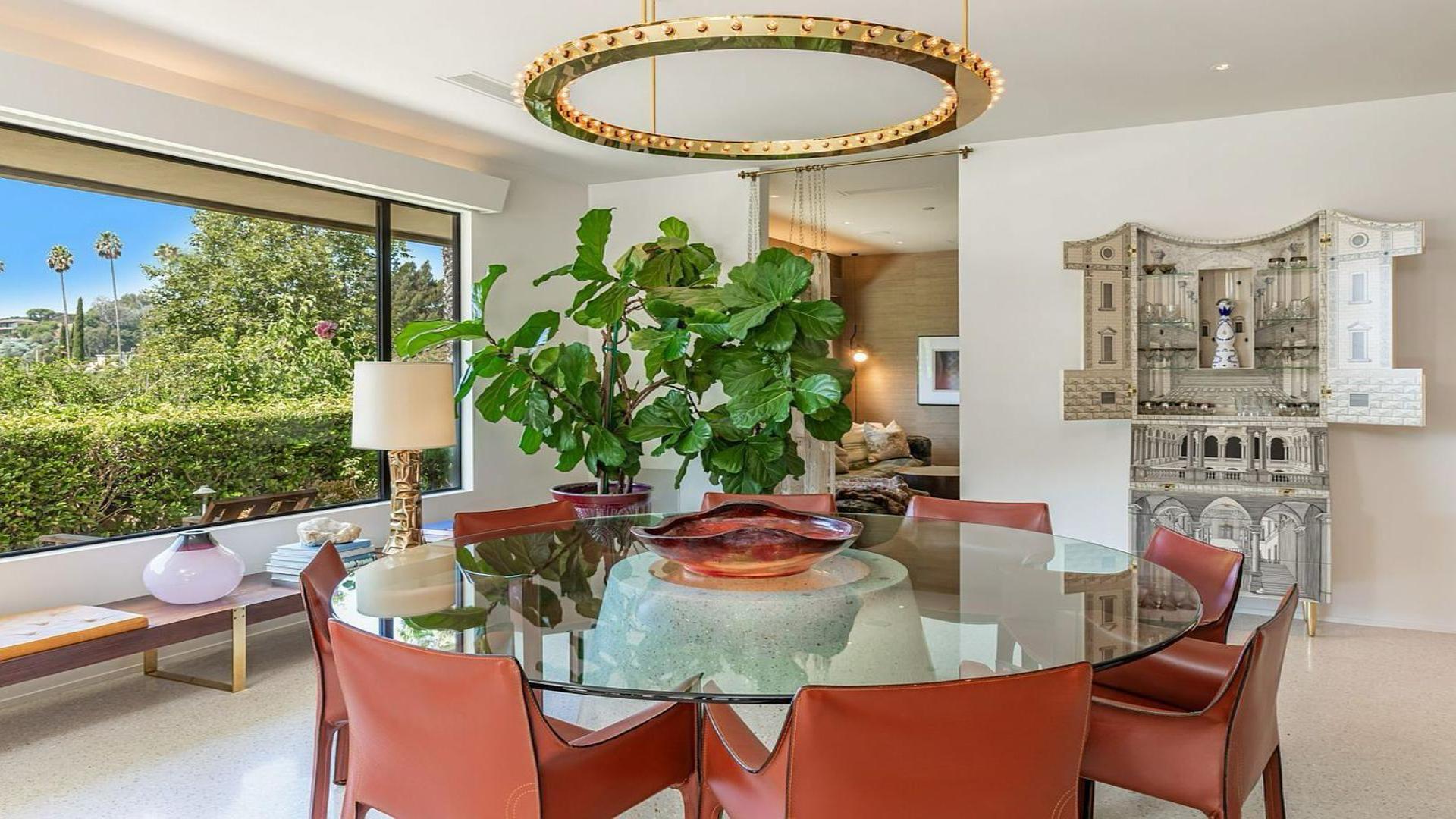 Mid-century Beverly Hills villa interior with stone fireplace and elegant dining area