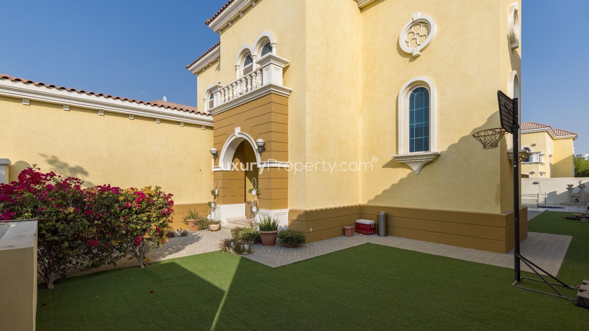 "Spacious living area with wooden floors in Jumeirah Park Legacy Villa, LP09000 for sale.",Exterior of spacious three-bedroom Legacy Villa with landscaped garden in Jumeirah Park