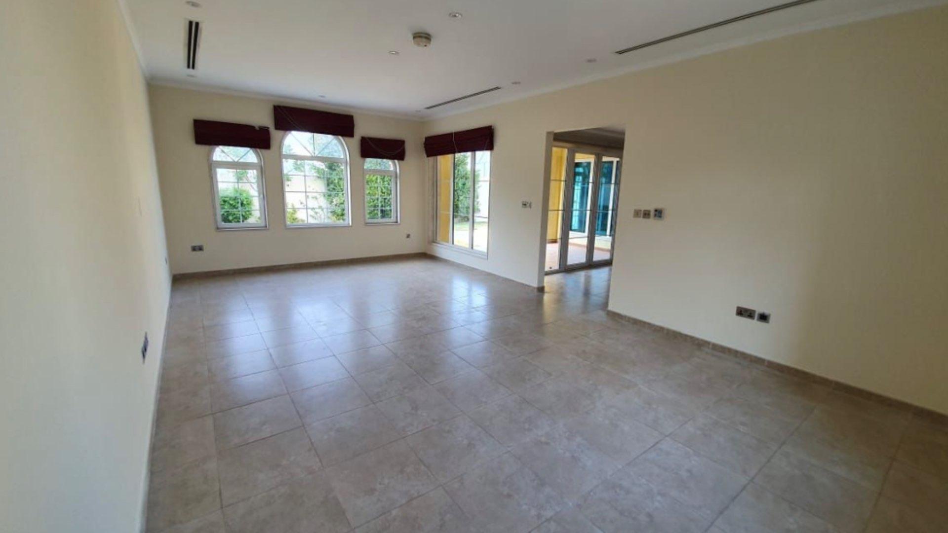 "Charming 3-bedroom villa on corner plot in Jumeirah Park Legacy, for sale.",Spacious living room in Jumeirah Park villa for sale, featuring large windows and tile flooring