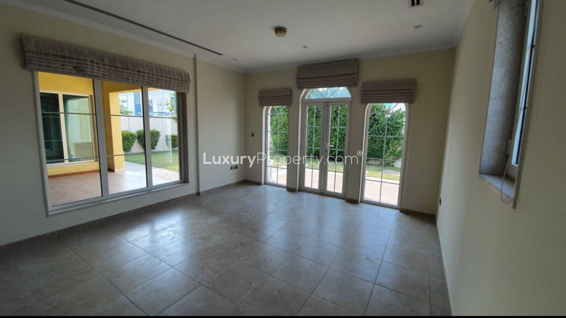 Spacious living room with large windows in Jumeirah Park Legacy villa for sale