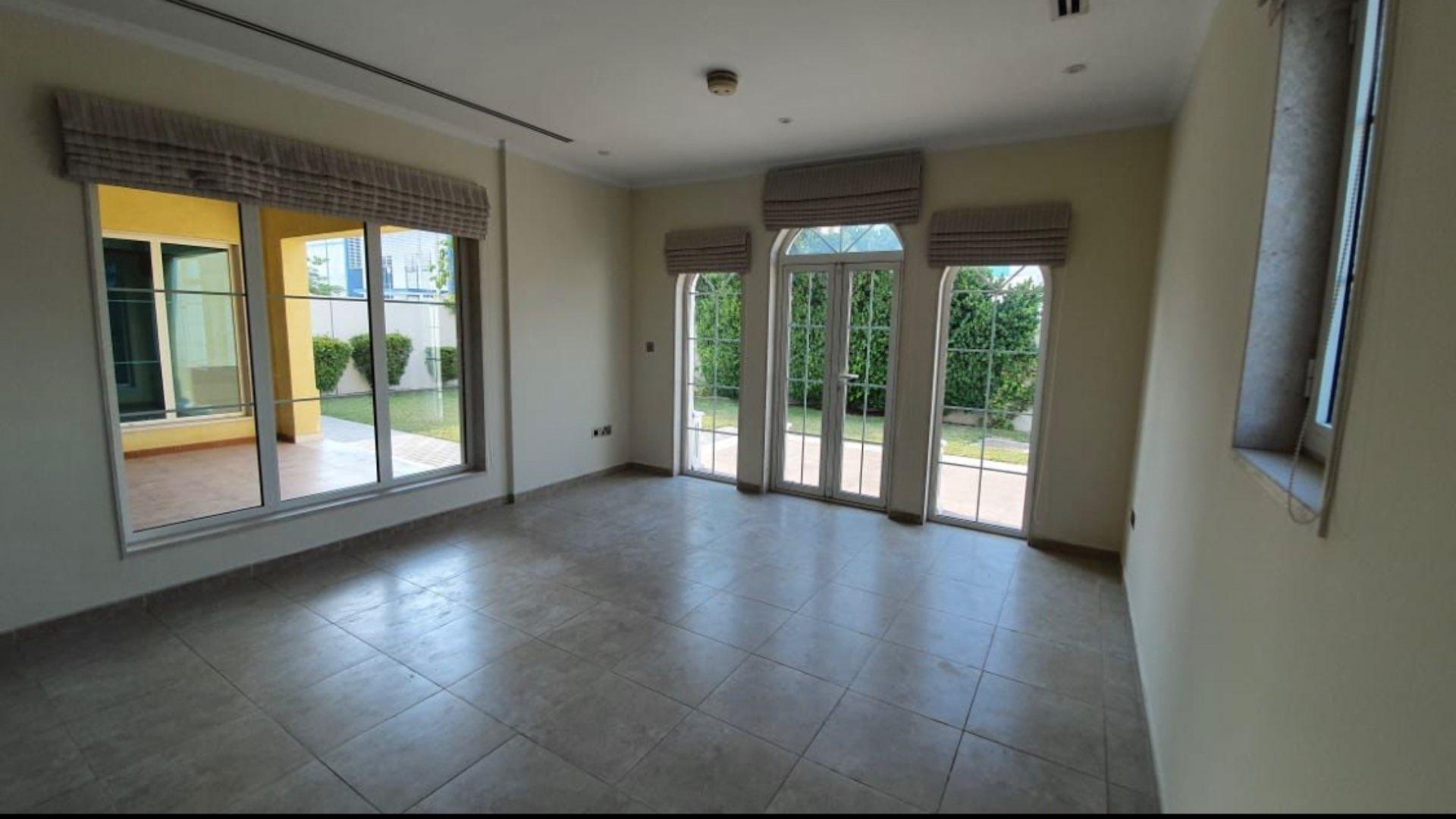 Spacious living room with large windows in Jumeirah Park Legacy villa for sale
