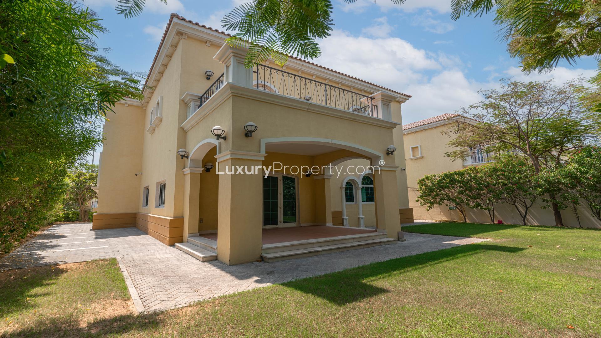 Spacious living room in Jumeirah Park villa, large windows, bright interior, tiled floor