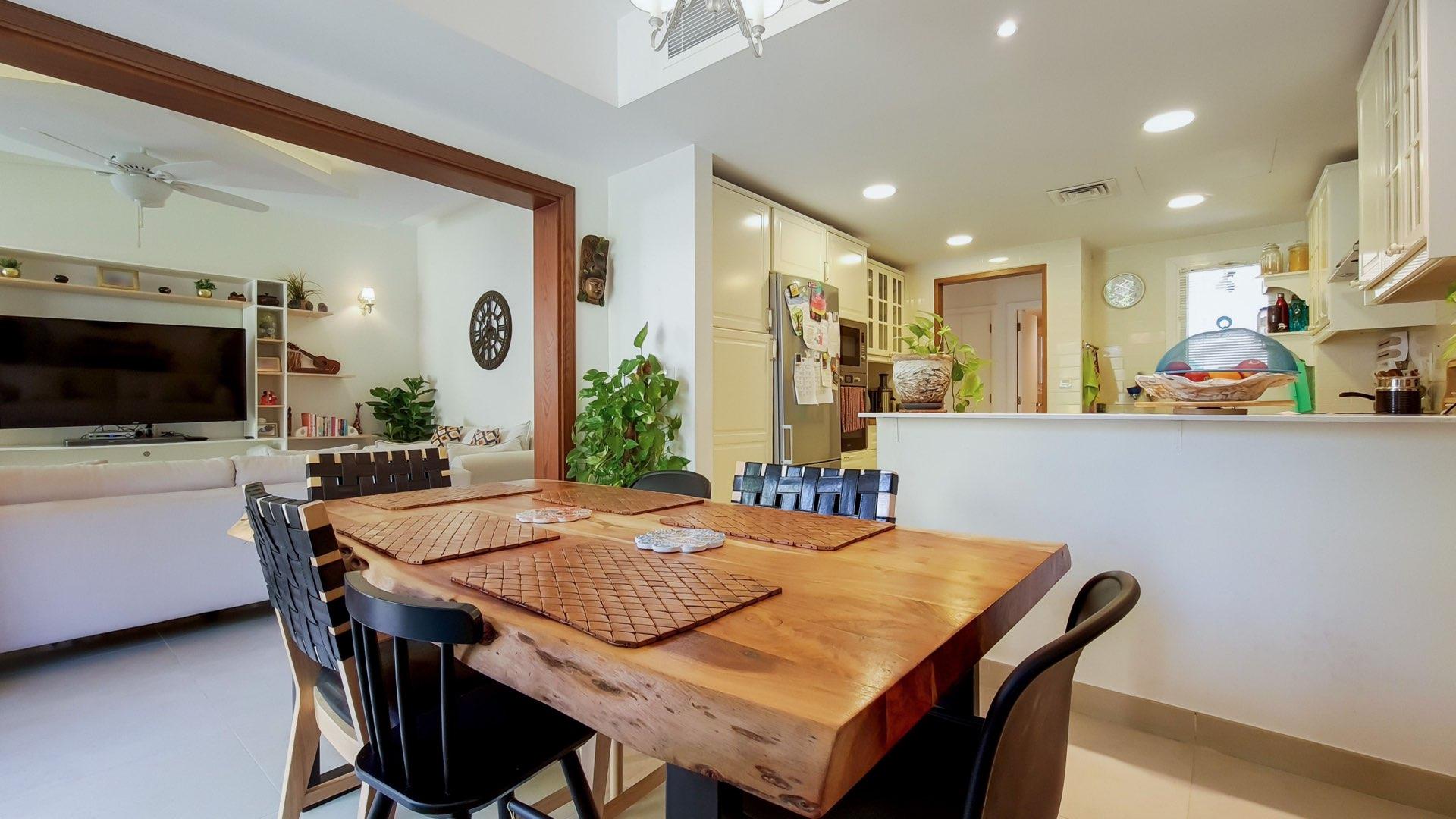 Dining and living area in Maeen villa for sale, featuring modern kitchen and decor