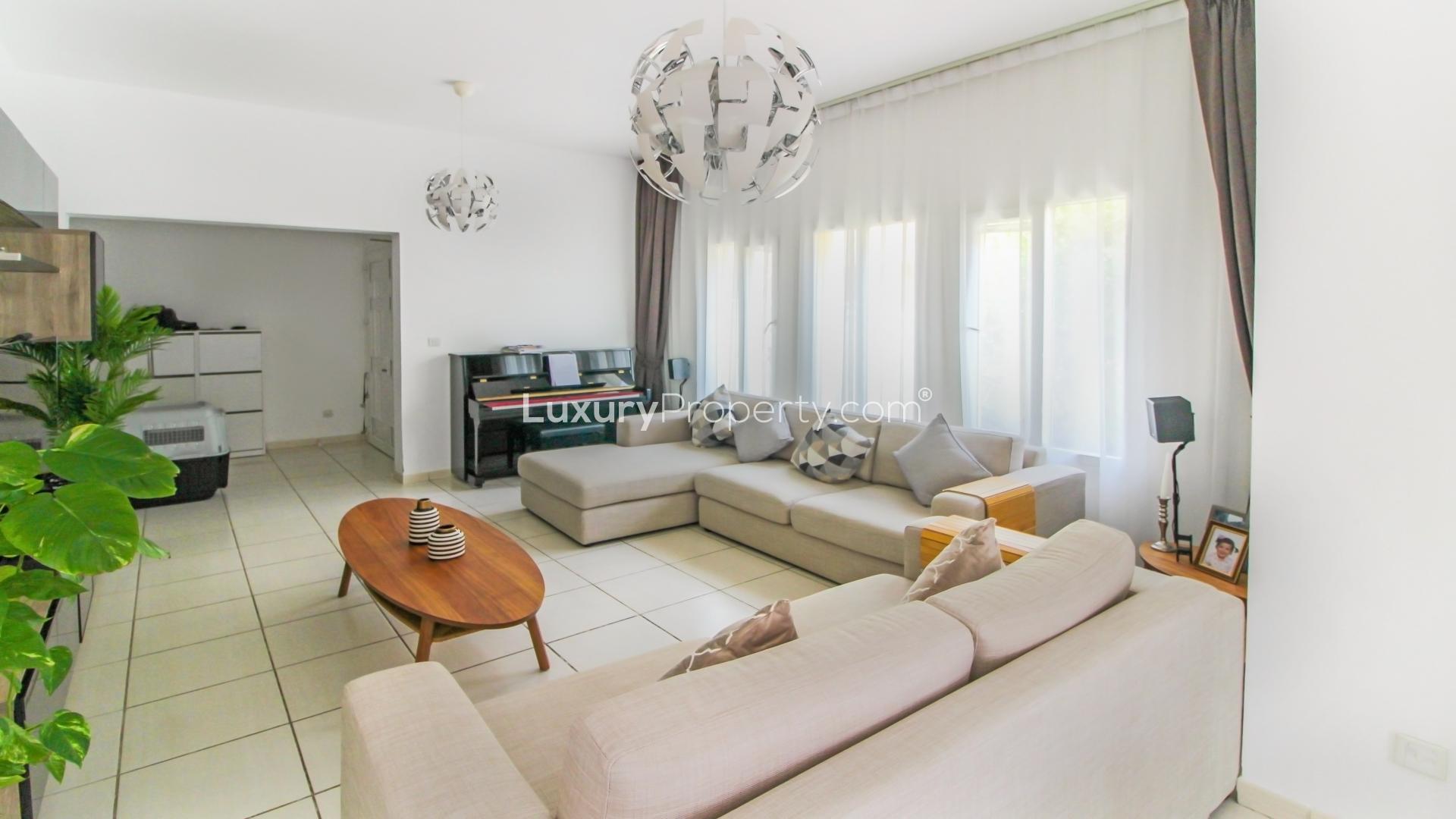Living room in Maeen villa, The Lakes, with modern decor and ample natural light