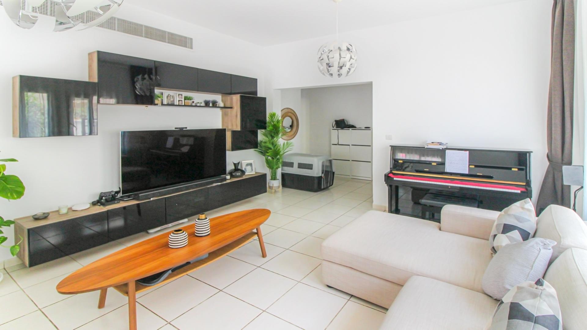Living room in Maeen villa, The Lakes, with modern decor and natural light