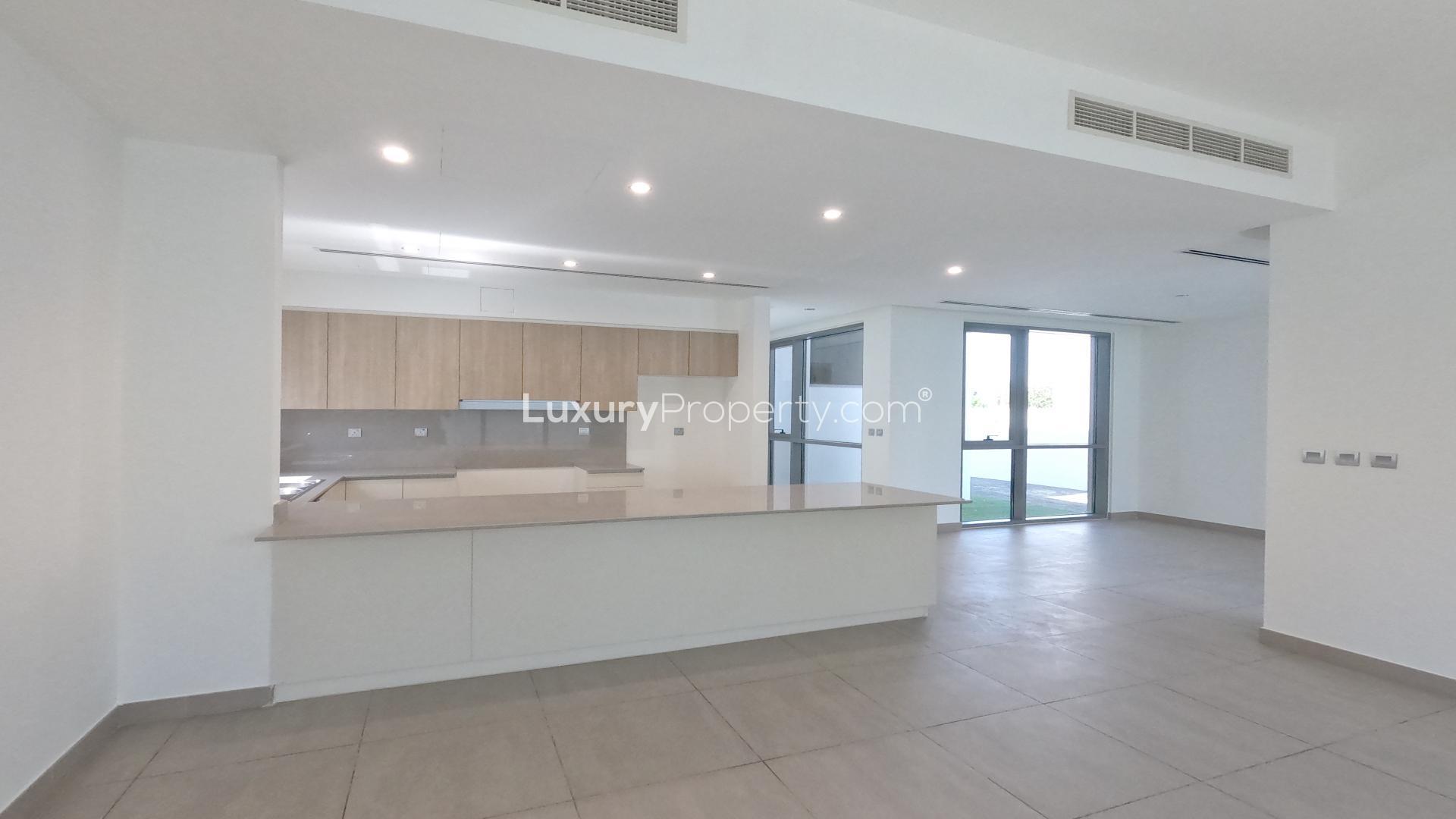 Modern kitchen and living area in Sidra Villas, Dubai Hills Estate, single-row villa