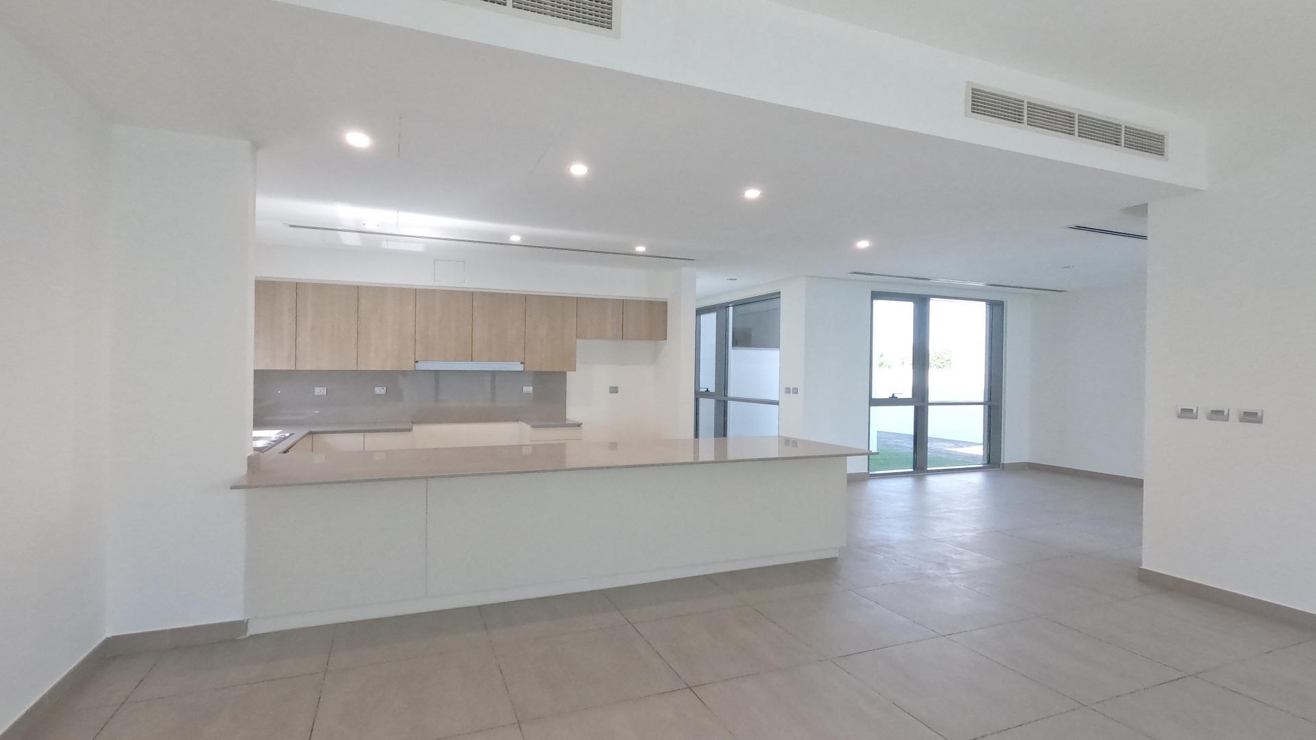Modern kitchen and living area in Sidra Villas, Dubai Hills Estate, single-row villa