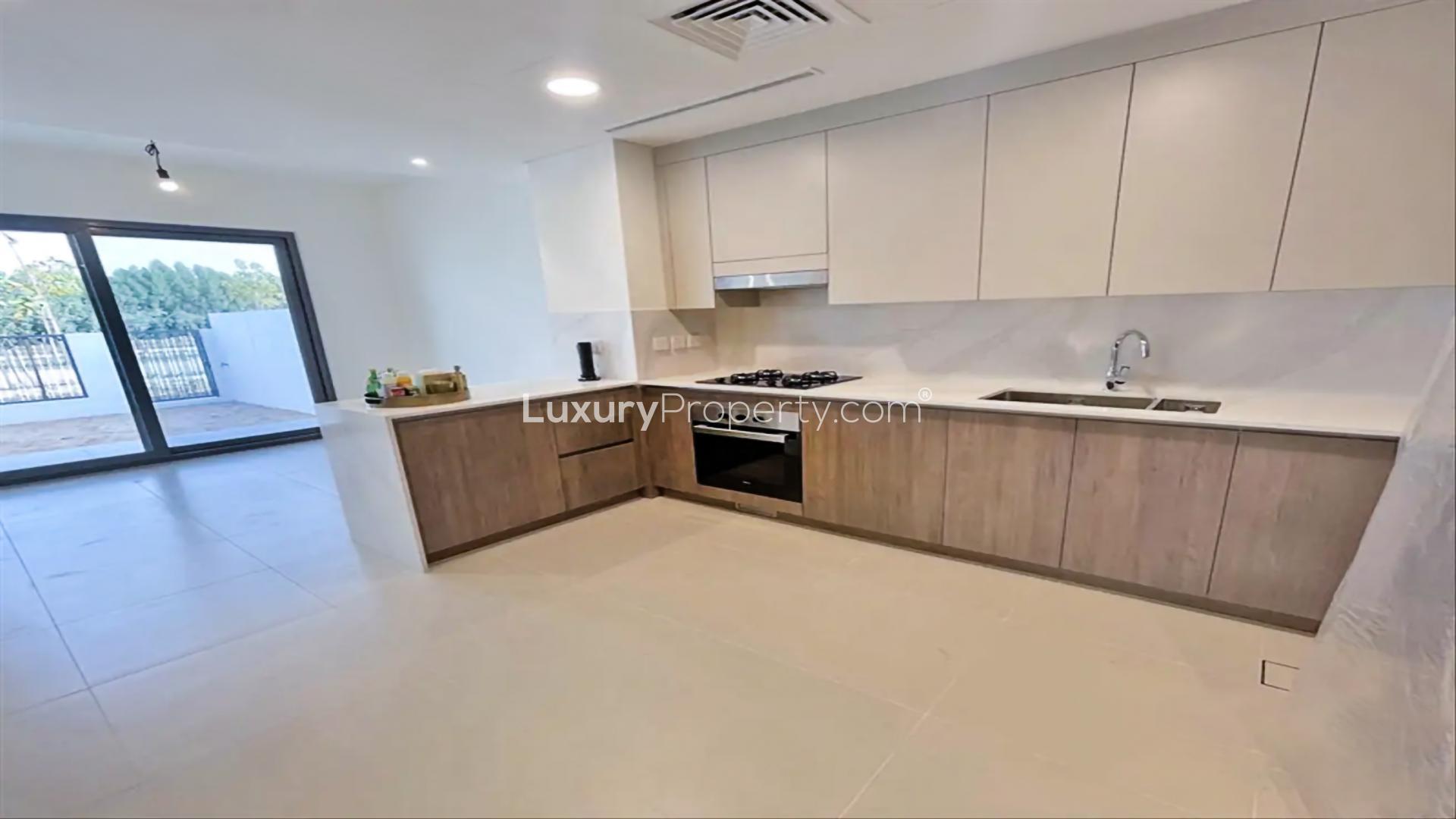 Spacious living area in Elan villa, Tilal Al Ghaf, with large windows and garden view