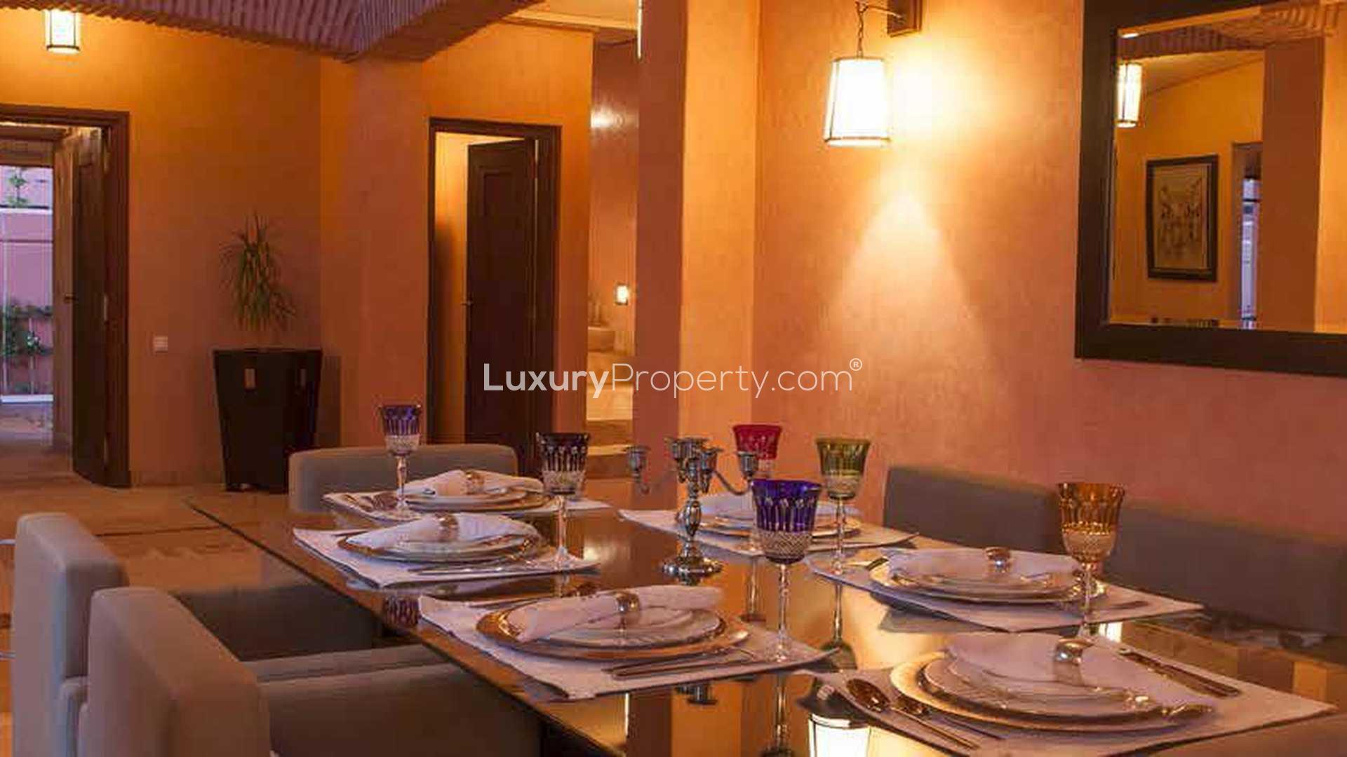 Elegant outdoor seating area with palm trees at Hattan Villa, Amelkis Resort, Marrakech