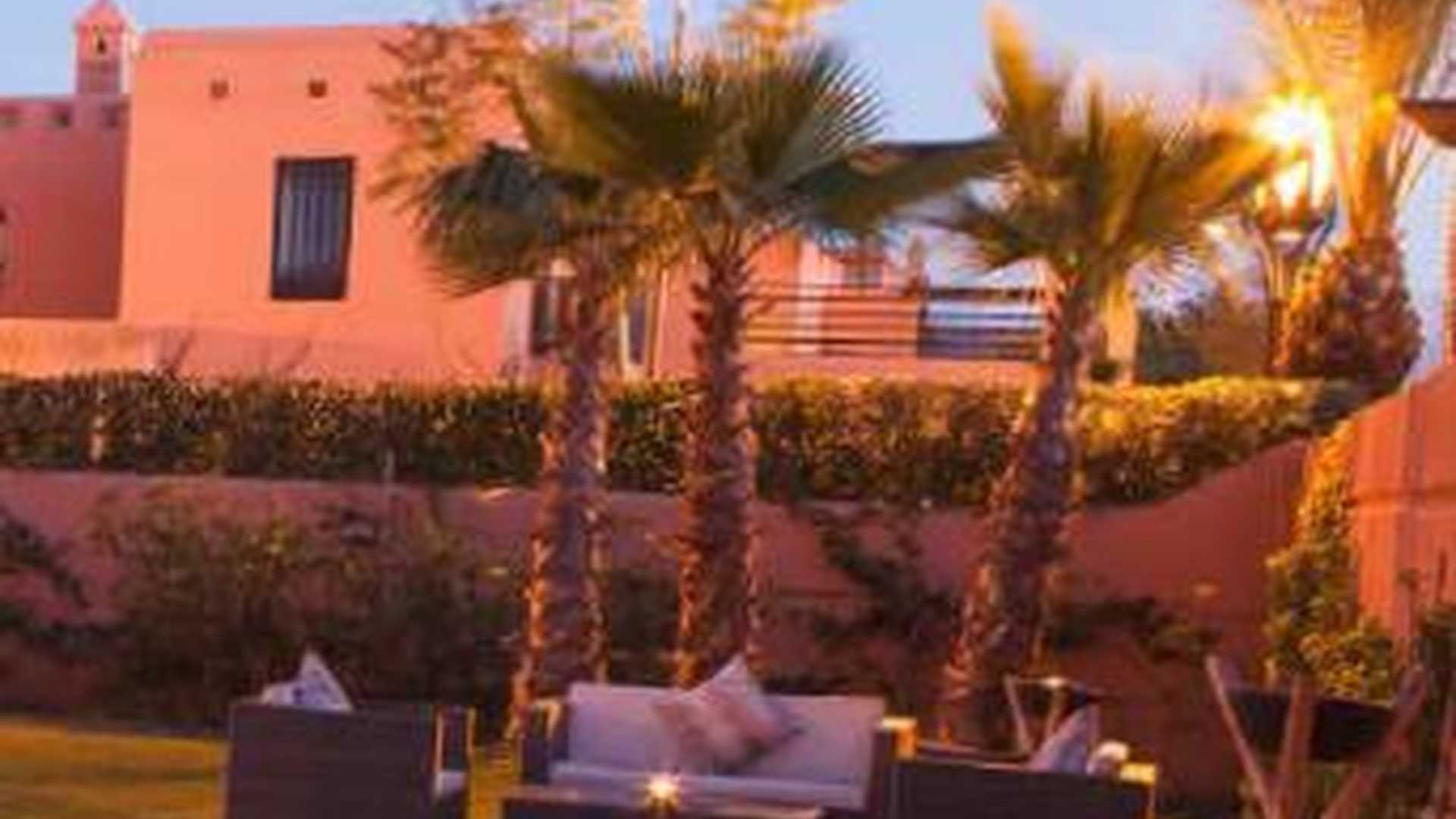 Gorgeous Hattan villa exterior with pool at sunset, Amelkis Resort, Marrakech, Morocco