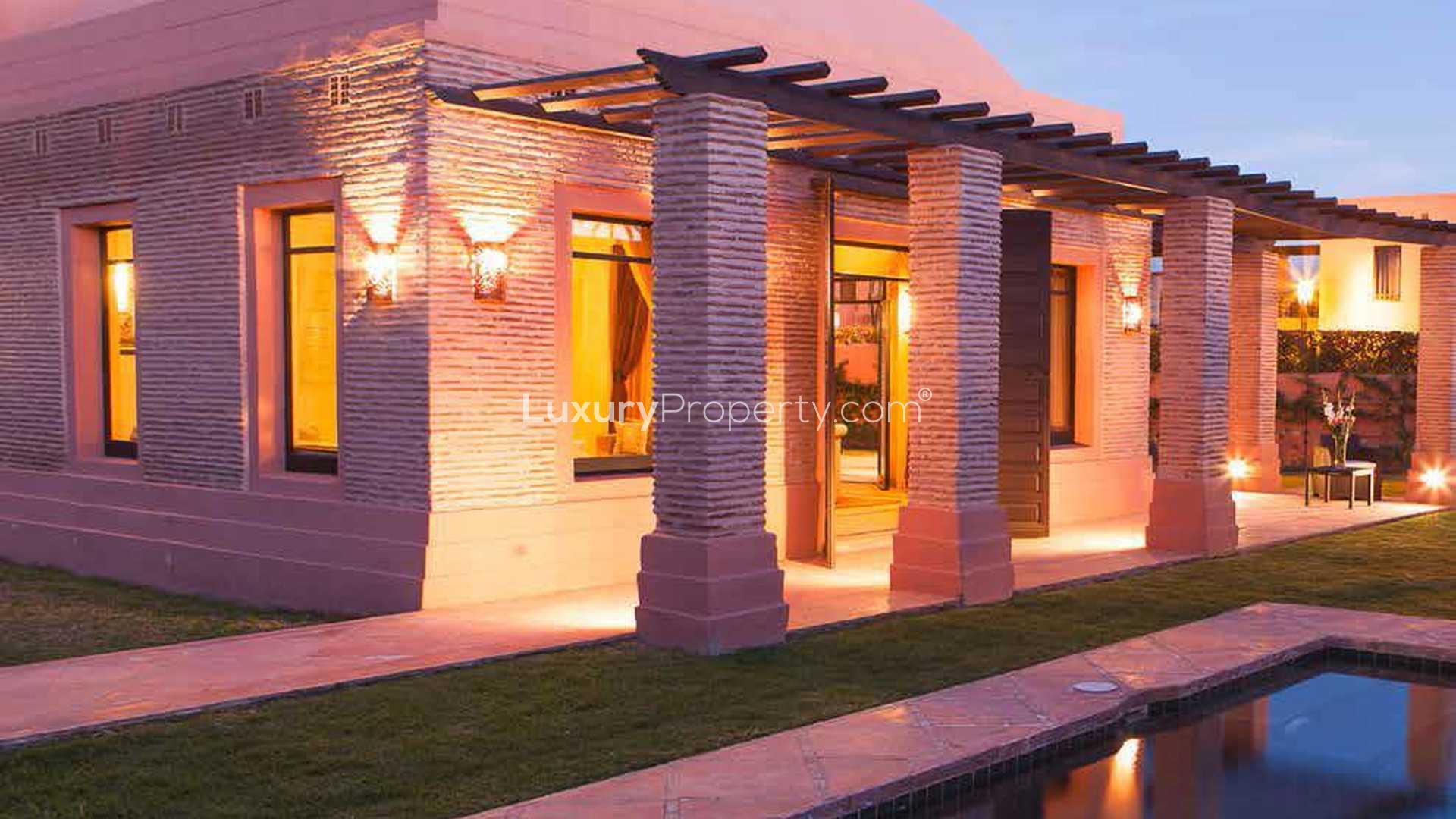 Luxurious bedroom in Hattan Villa, Amelkis Resort, Marrakech, featuring elegant decor and lighting