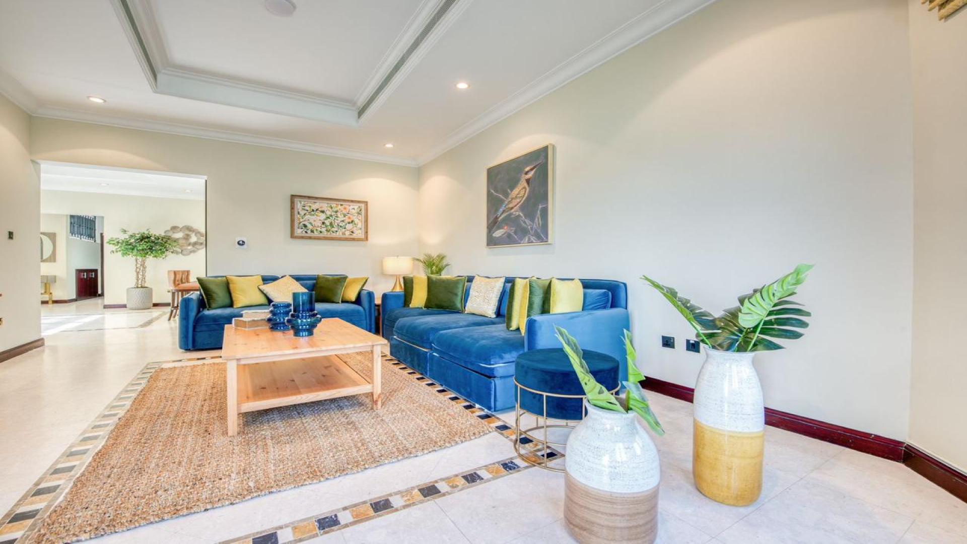 Luxurious living room in Palm Jumeirah villa, featuring elegant decor and spacious seating area