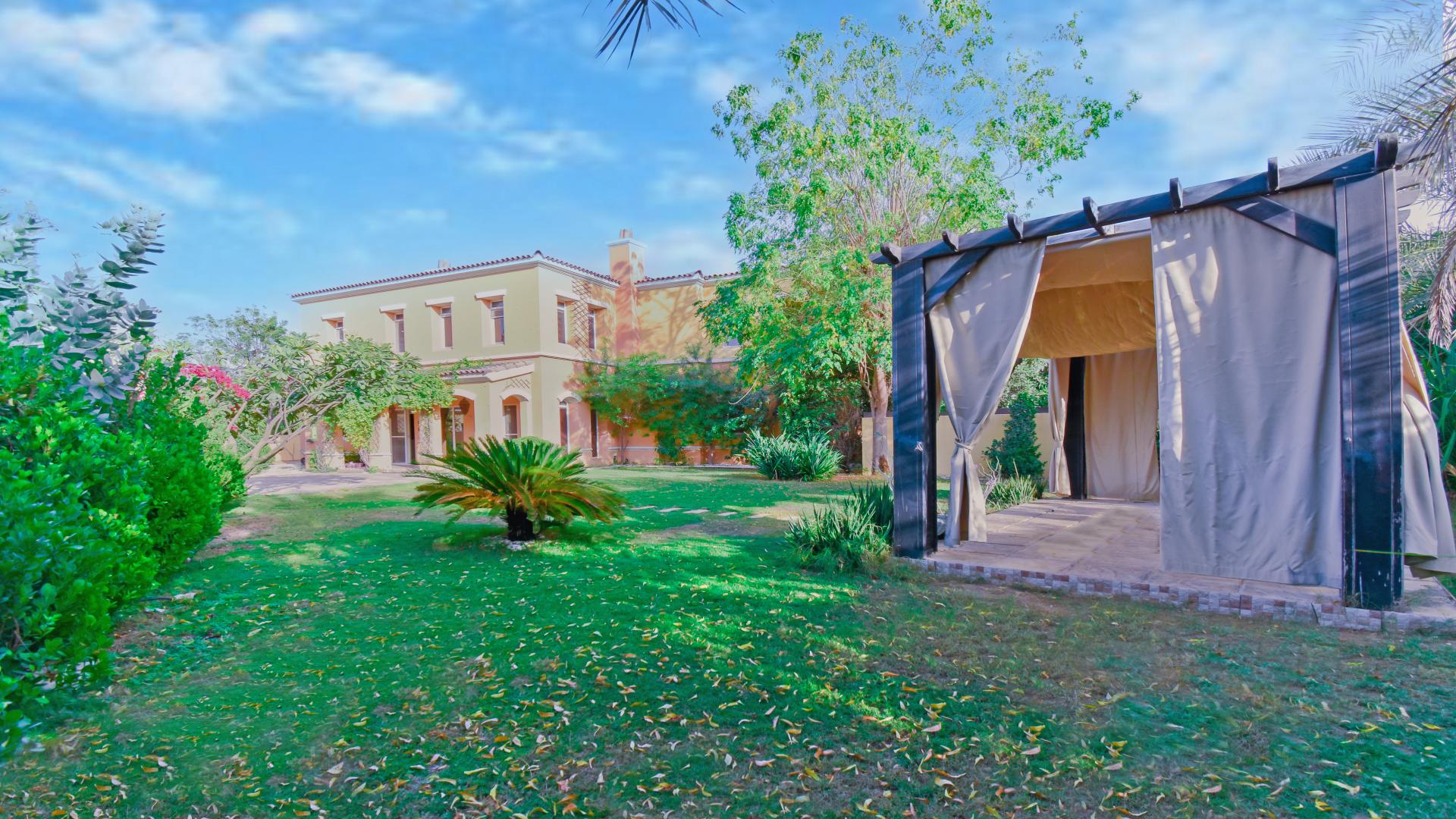 Exterior view of lush garden in upgraded villa, Palmera, Arabian Ranches, for sale