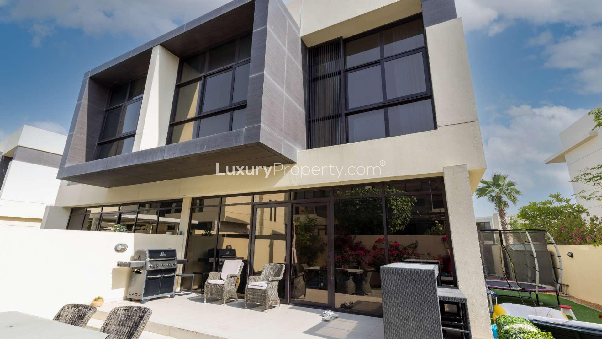 Contemporary living room in 3-bedroom villa, Queens Meadow, Damac Hills, with garden view