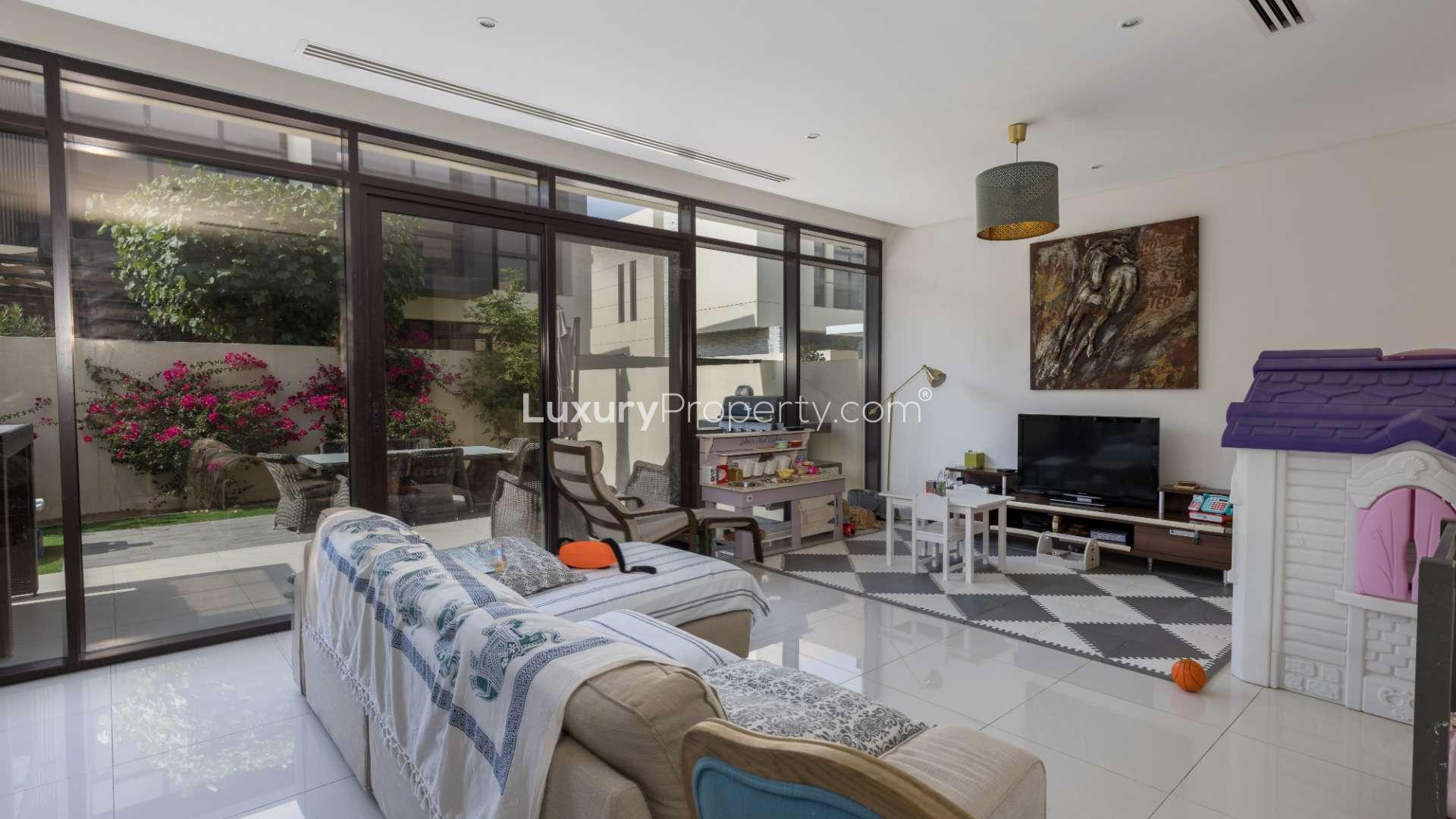 Contemporary 3-bedroom villa exterior in Queens Meadow, DAMAC Hills, with driveway and palm trees