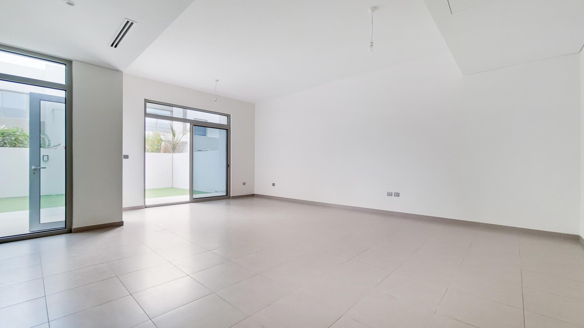 "Spacious backyard of single row villa in Reem Community, Arabian Ranches 2, for sale.",Spacious living area in single row villa, Reem Community, Arabian Ranches 2, for sale