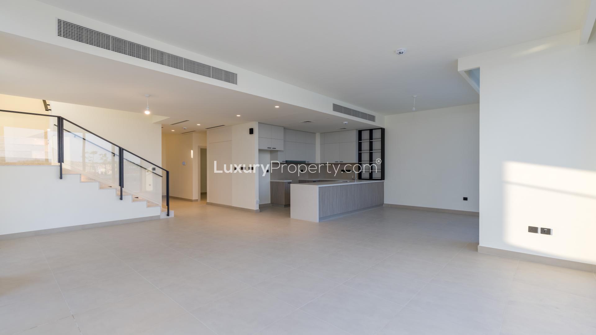 Spacious living area with large windows and golf course views in Golf Grove villa