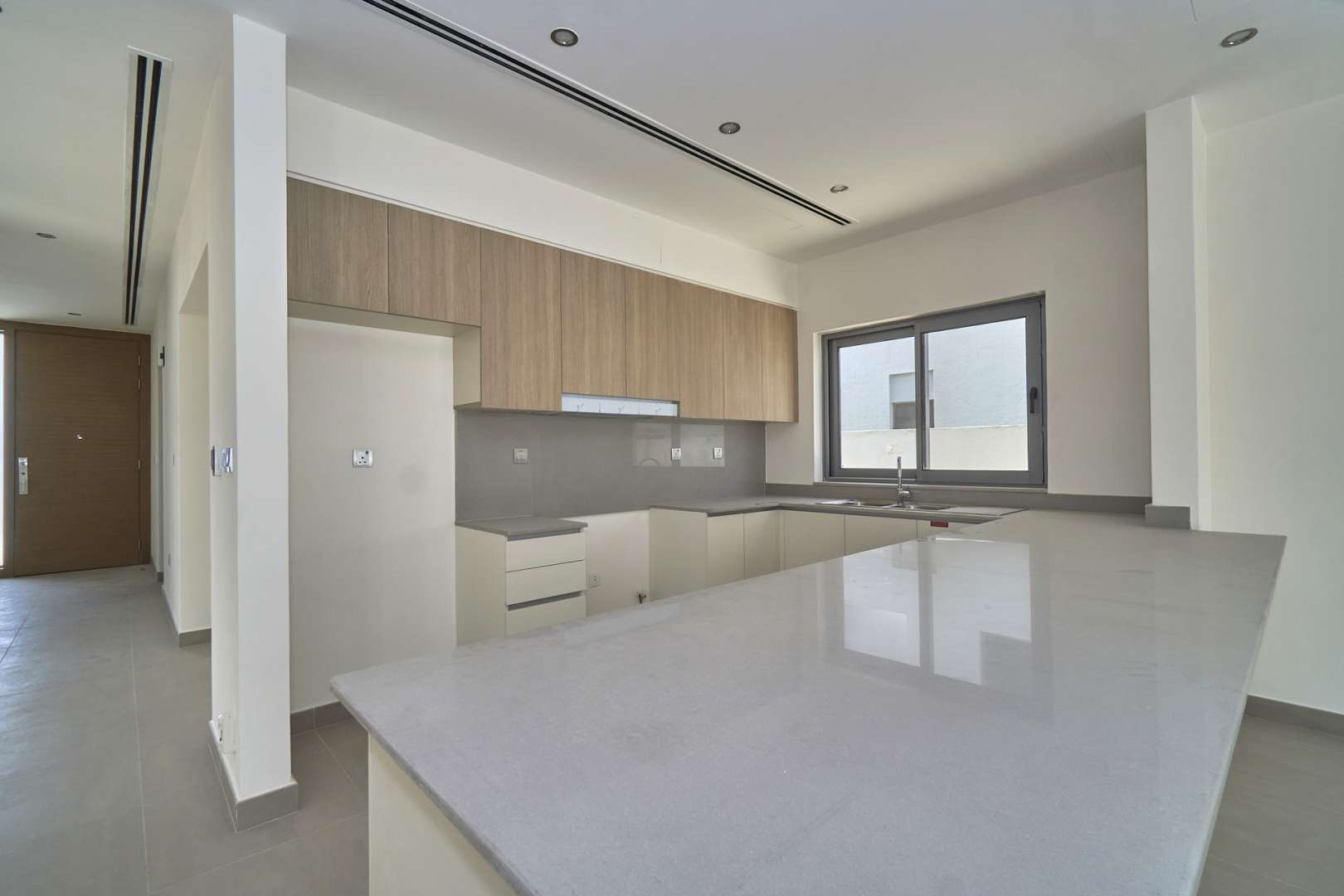 Empty living room with large sliding glass doors in Sidra Villas, Dubai Hills Estate