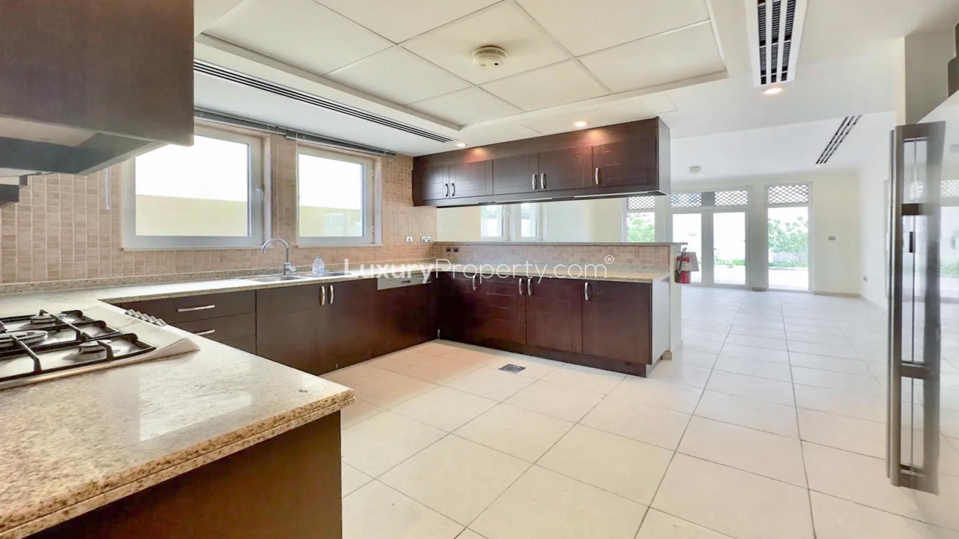 Elegant kitchen in 3-bedroom Jumeirah Park villa, featuring modern cabinetry and granite countertops