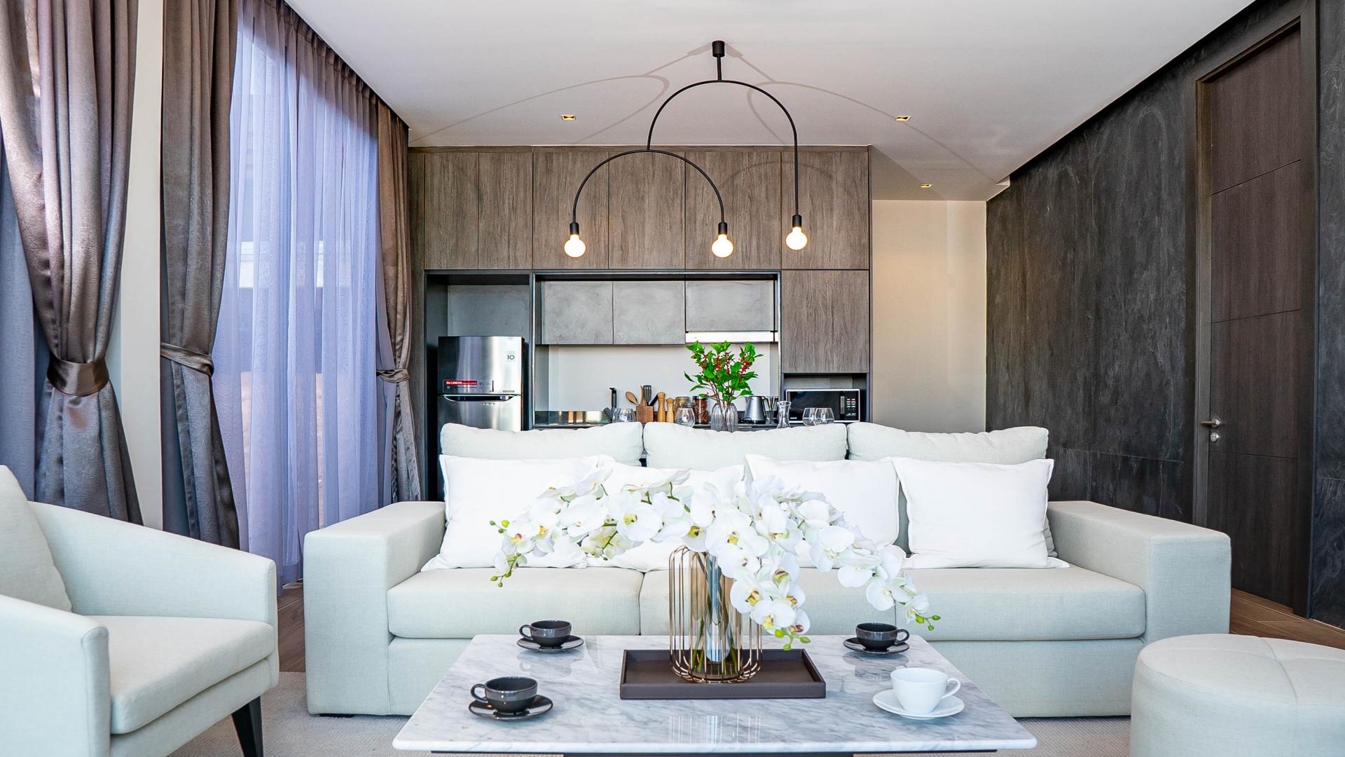 Modern living room in Thalang villa, Phuket, with elegant decor and open kitchen