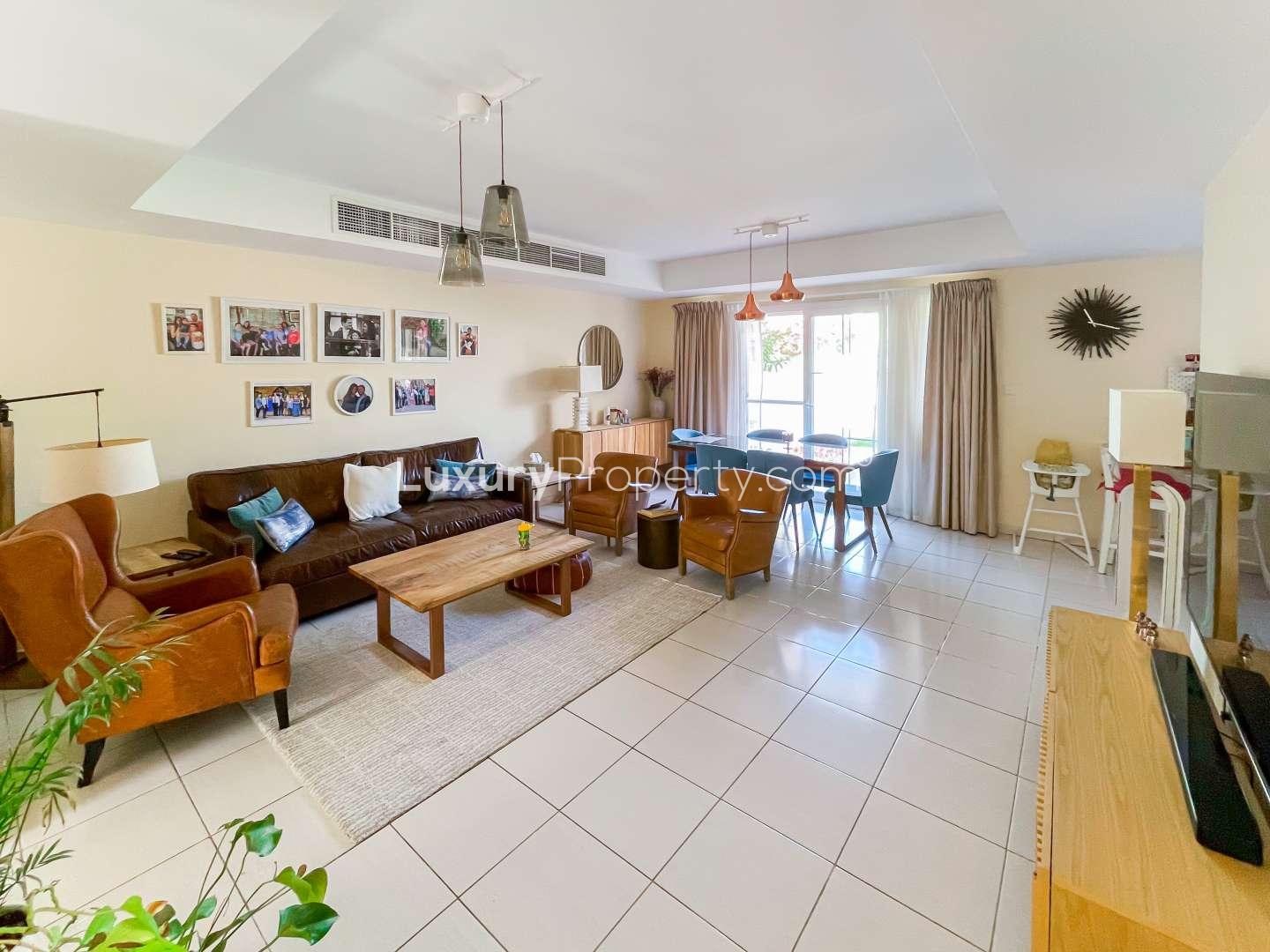 Exterior view of 3-bedroom villa in Springs 11 with lush garden and patio