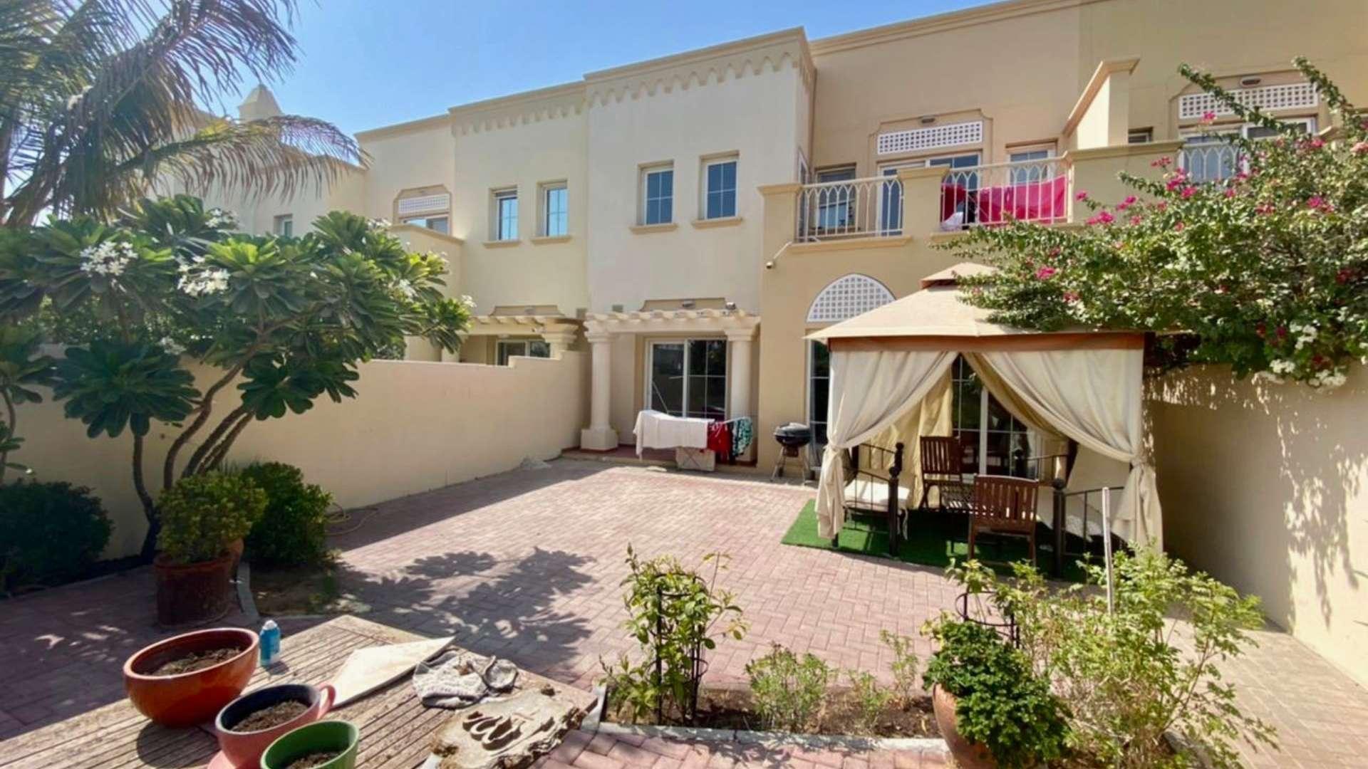 Park view from three-bedroom villa in Springs 11, featuring lush greenery and tennis court