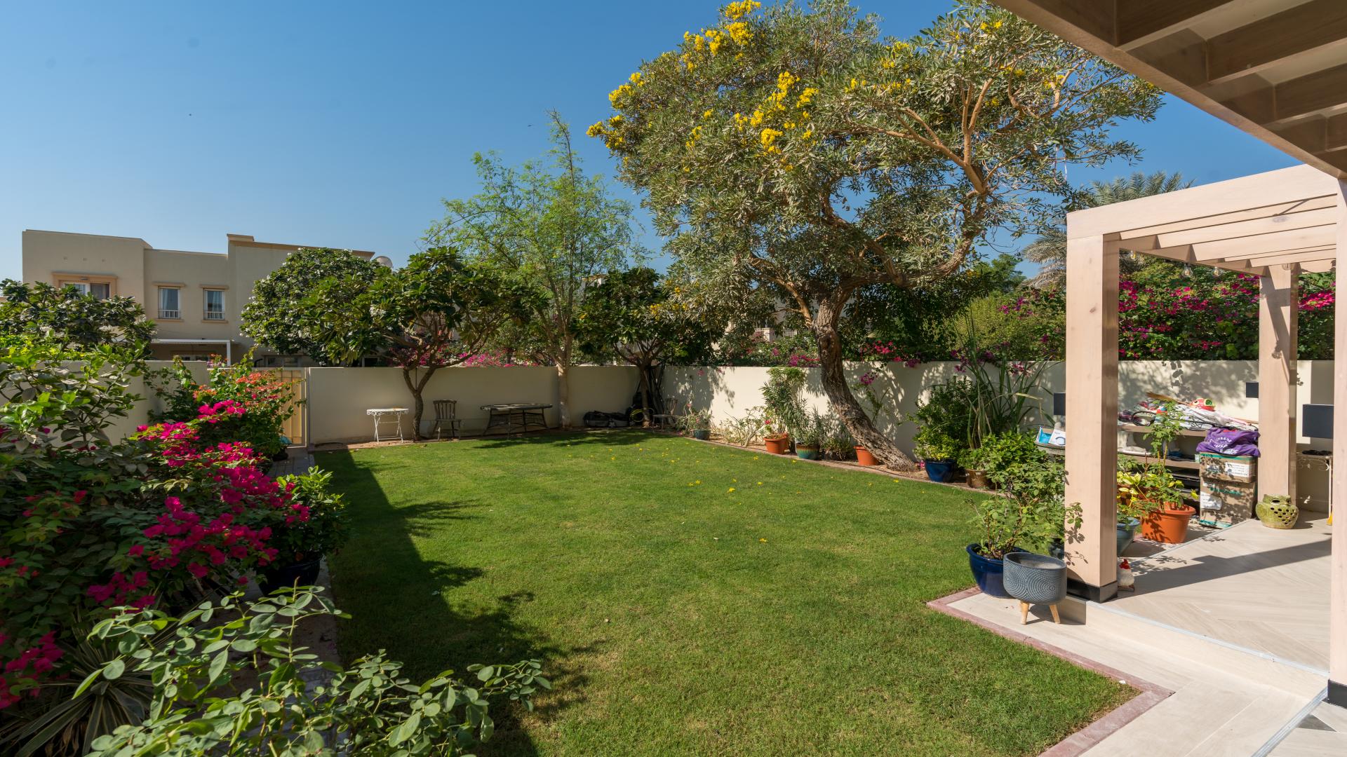 Living room of upgraded villa in The Springs with garden view through sliding doors