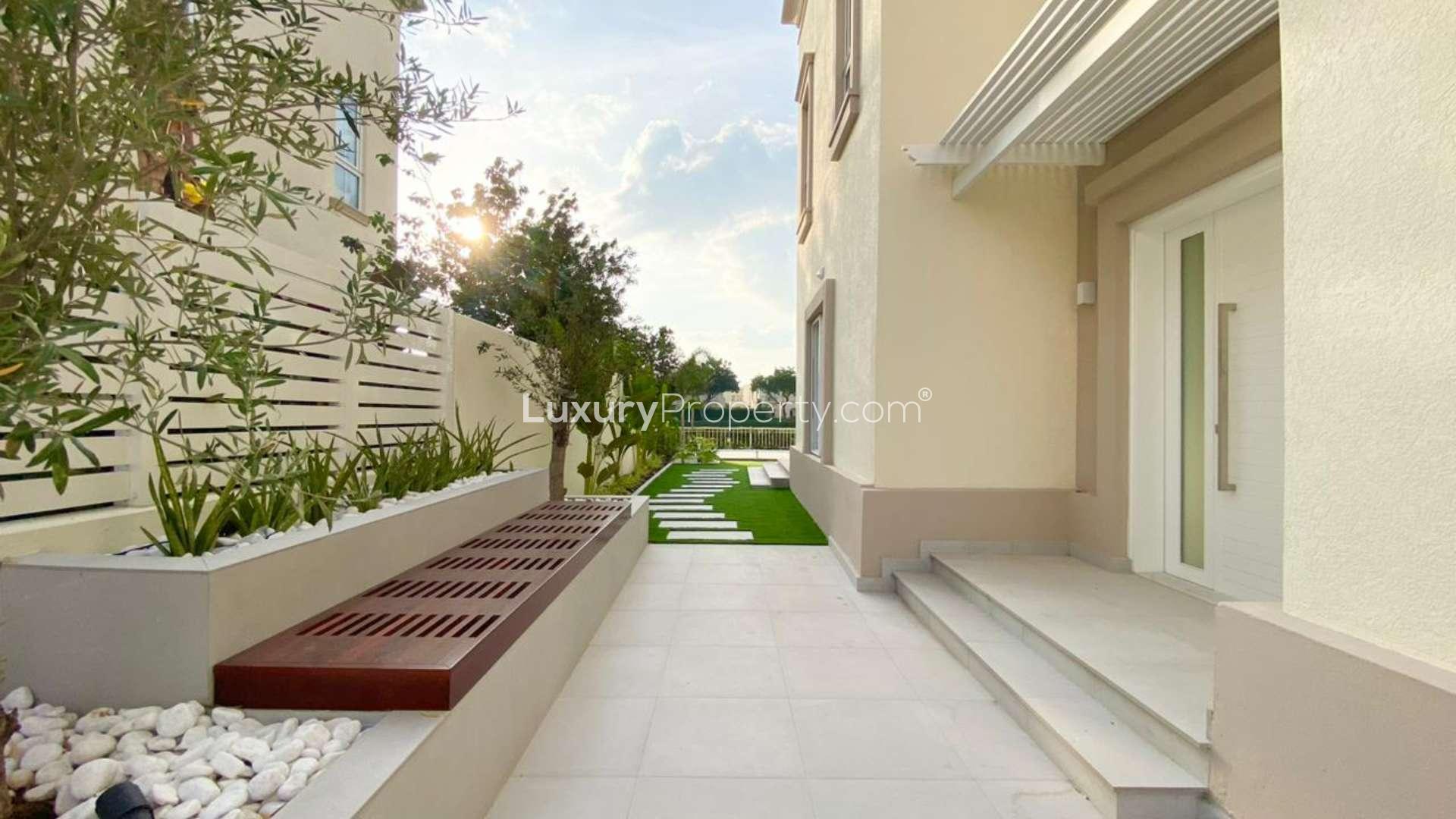 Beautifully landscaped entrance of renovated villa in Springs 4 with lake views