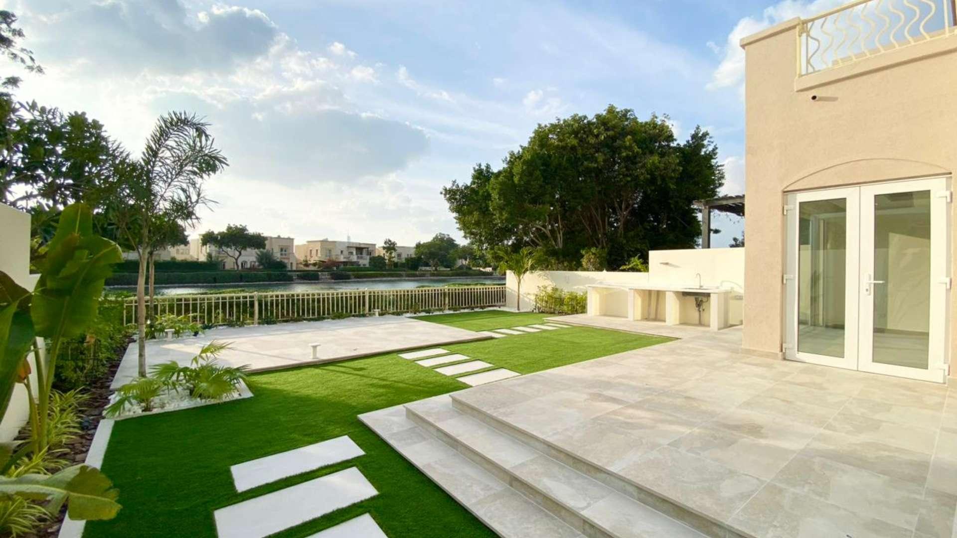 "Renovated Type 1E villa exterior with garden, Springs 4, Emirates Living, for sale.",Renovated villa patio with lake views in Springs 4, Emirates Living community