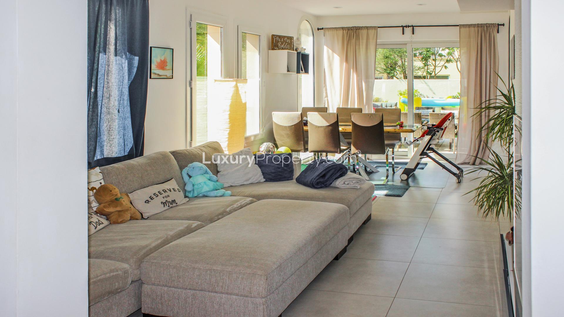 Villa backyard with patio, outdoor dining, and play area in Springs 14 for sale