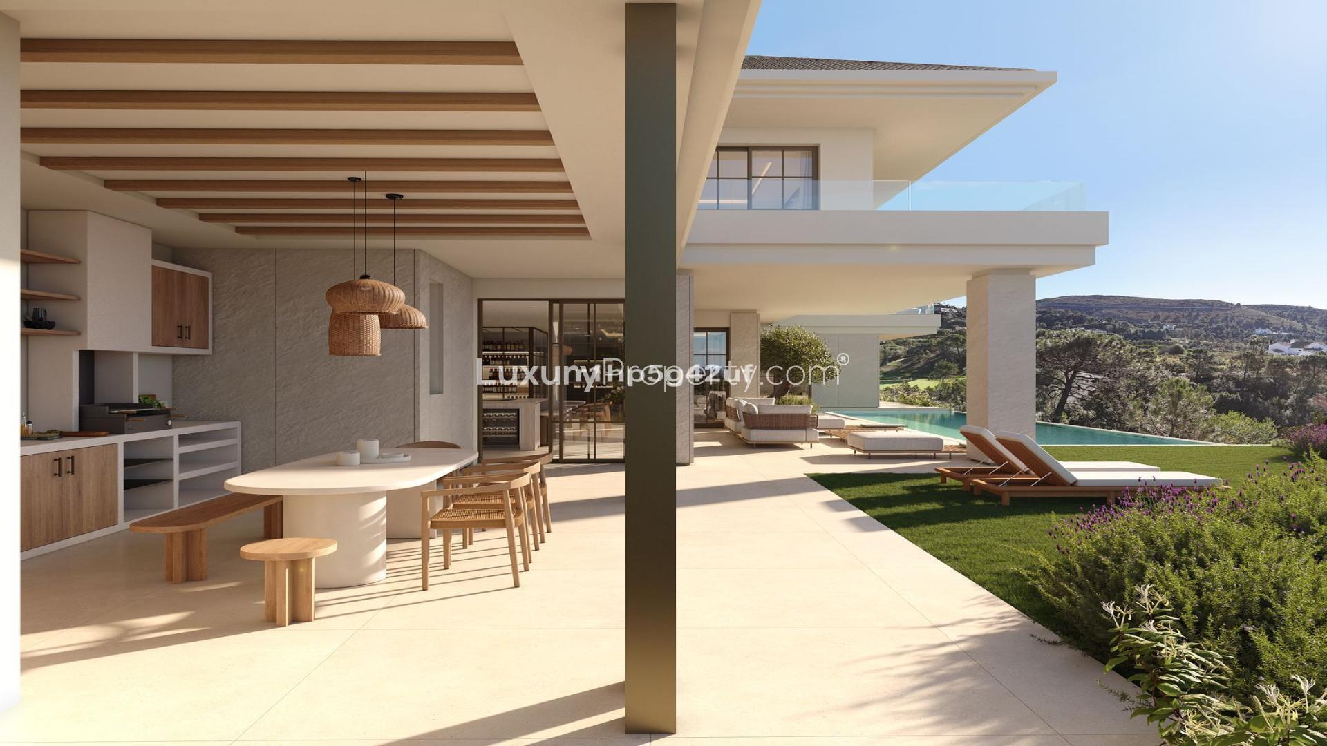 Luxurious Benahavís villa living room with panoramic golf and sea views through large windows