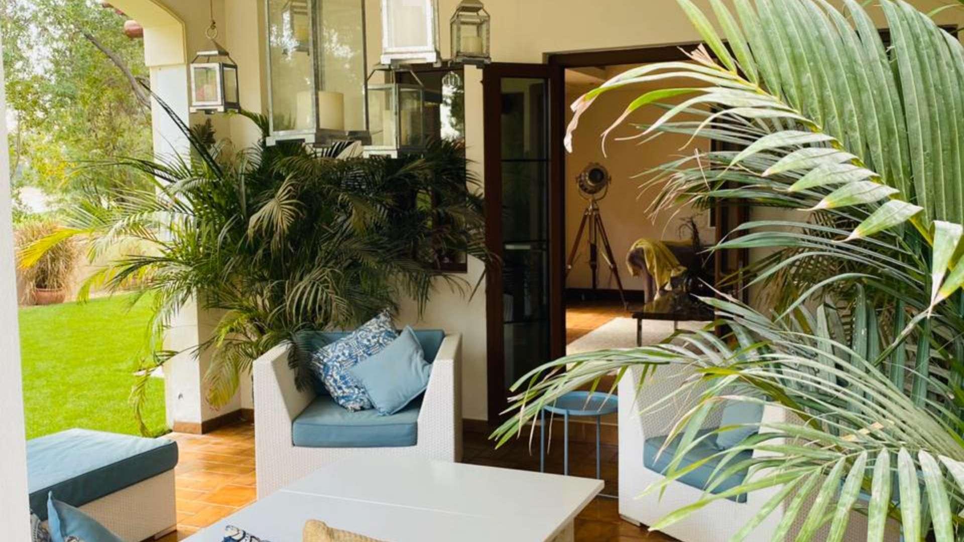 Garden view of villa with lush greenery at Jumeirah Golf Estates, Earth community