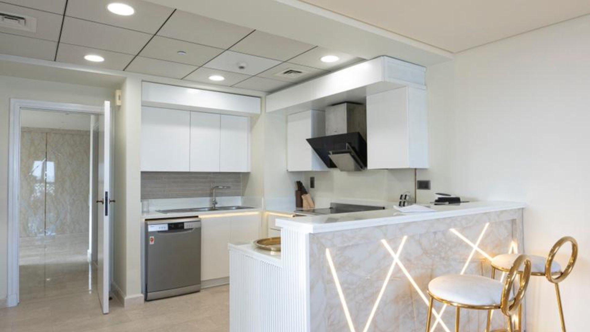 Luxurious living room in fully furnished Palm Jumeirah penthouse with modern decor and ample sunlight