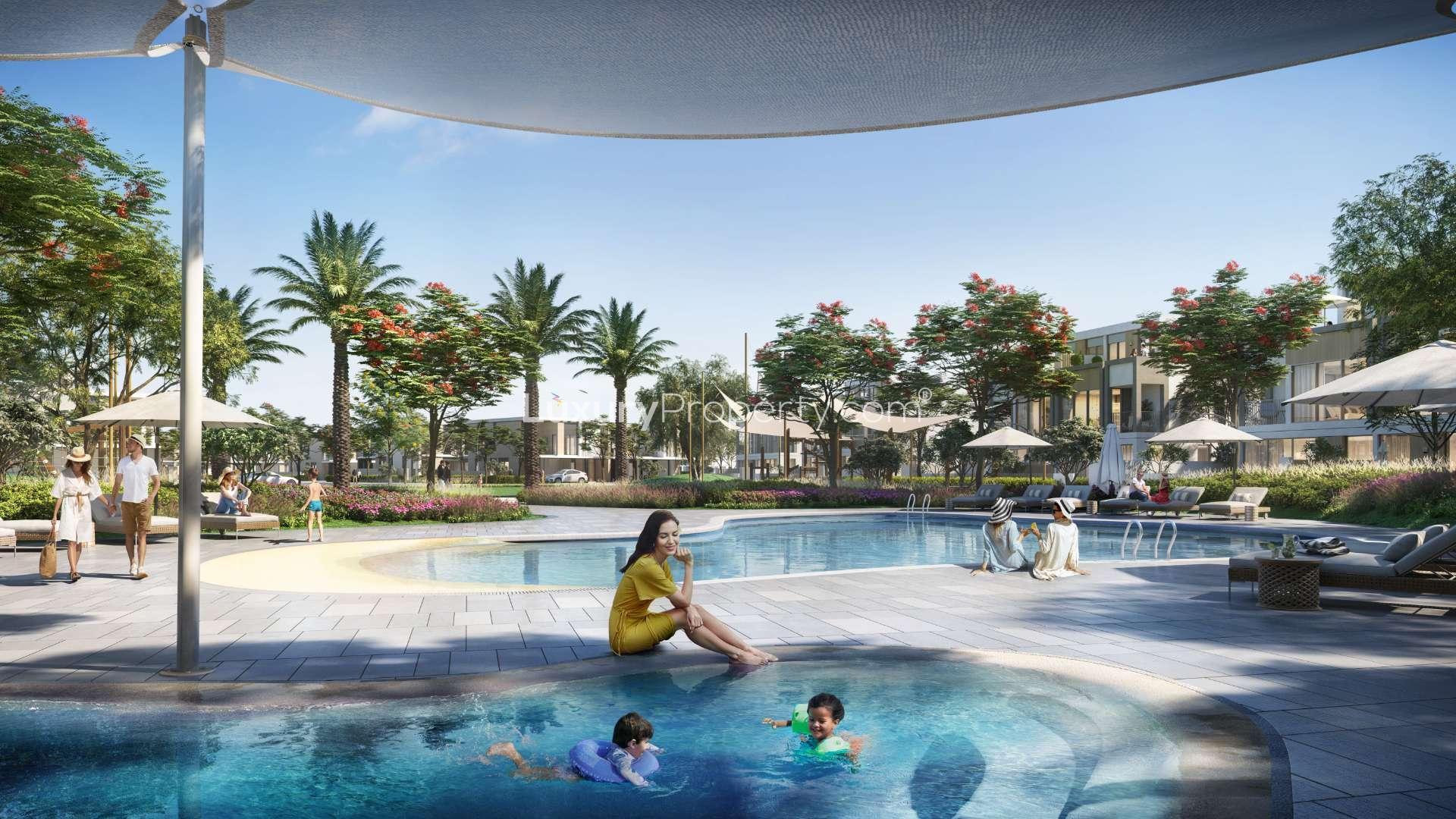 Twin villa exterior in Tilal Al Ghaf's Aura community, surrounded by lush greenery