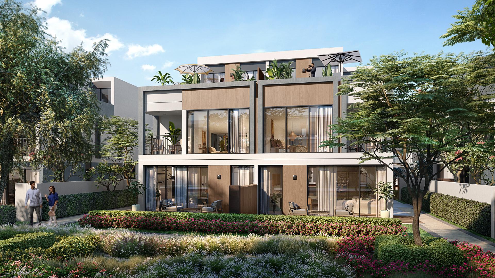 Twin villa in Tilal Al Ghaf's Aura community with modern design and lush landscaping