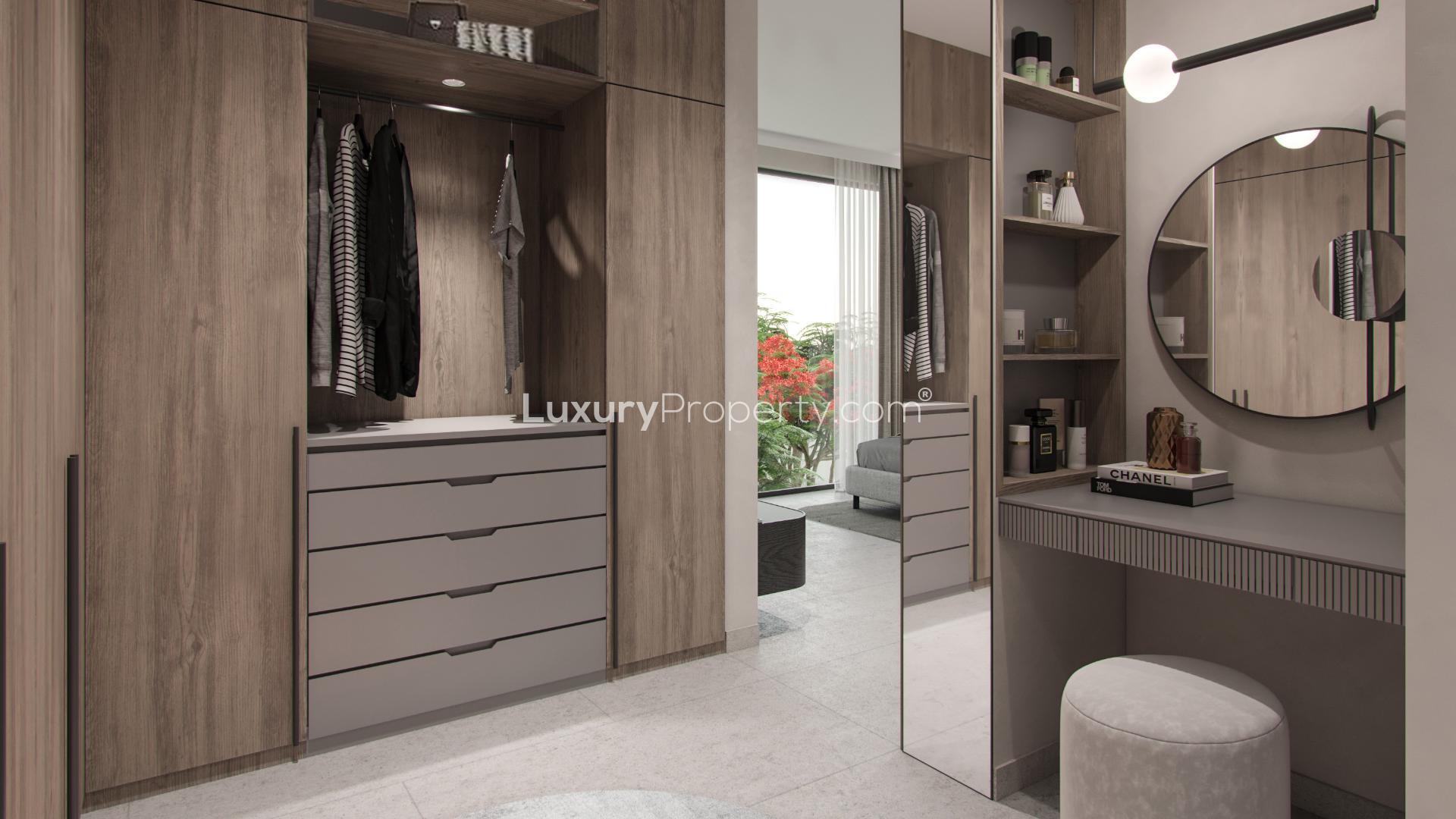 Stylish bedroom in 4-bedroom villa, Aura, Tilal Al Ghaf, featuring modern decor and large window