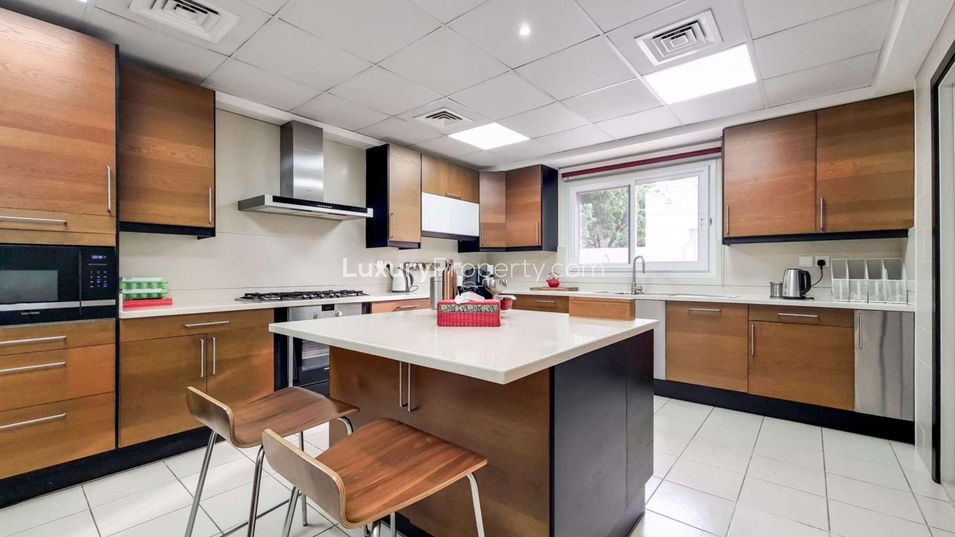 Sunny balcony view of upgraded 4-bedroom villa in Meadows 9, close to lake