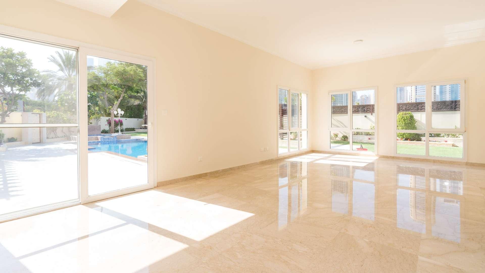 "Spacious entrance hall in upgraded Type 6 villa, Meadows, Emirates Living, for sale.",Bright living room with pool view in upgraded Meadows villa, Emirates Living