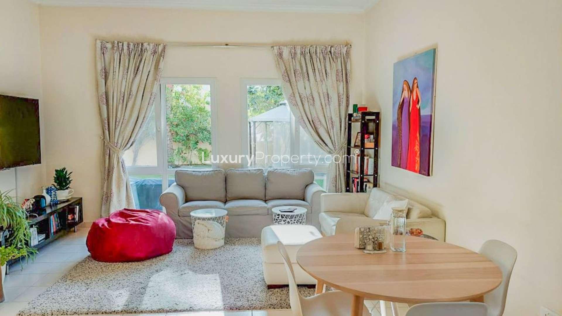 Living room in Meadows 9 villa with garden view, elegant decor, and natural light