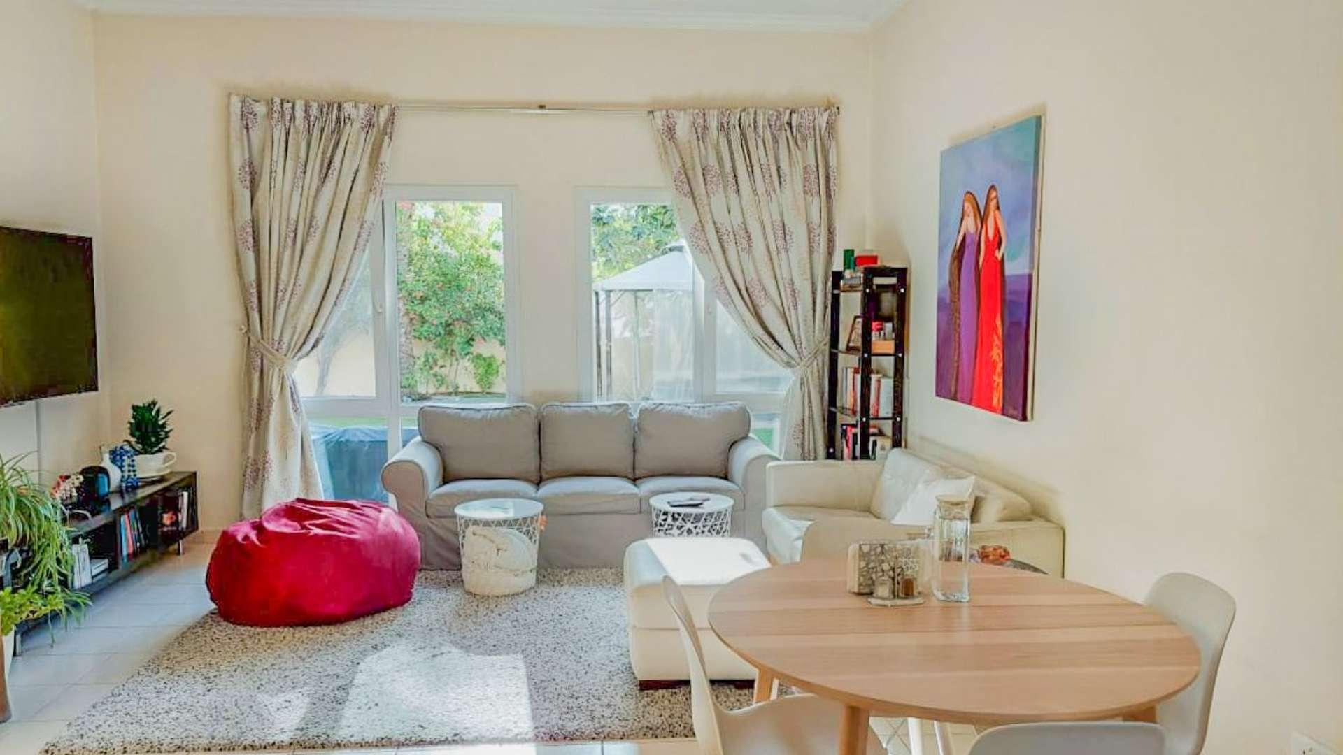 Living room in Meadows 9 villa with garden view, elegant decor, and natural light