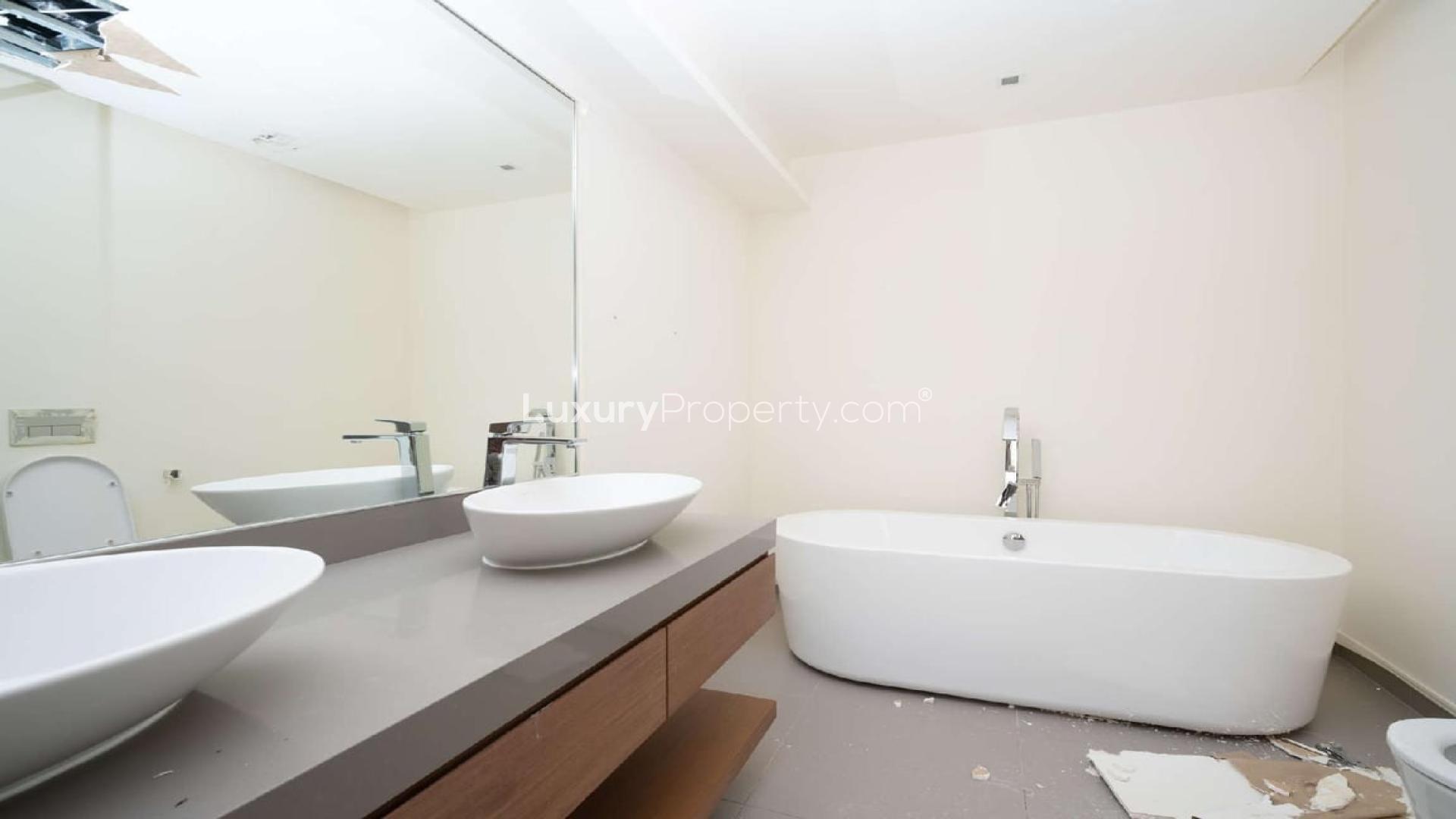 Modern duplex apartment interior with open kitchen and wooden staircase in City Walk, Jumeirah