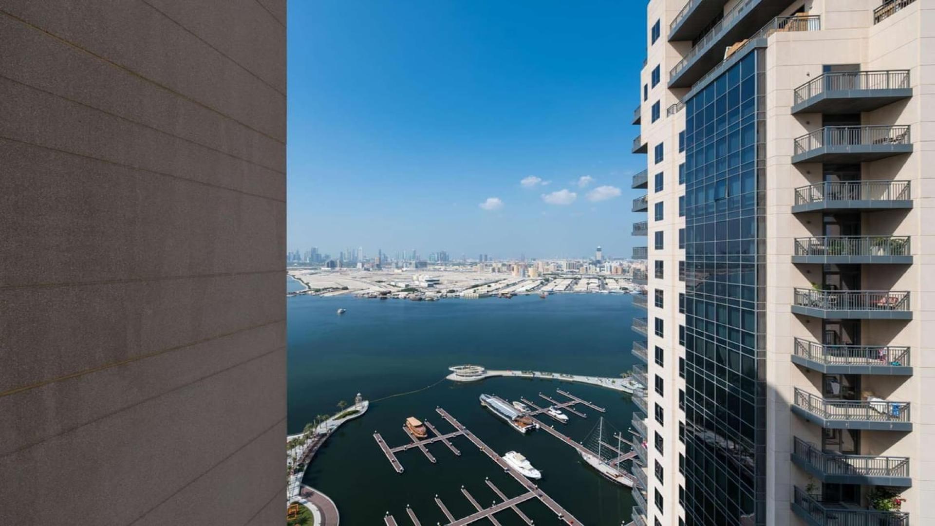 Spacious living area with large windows in Dubai Creek Harbour apartment for rent