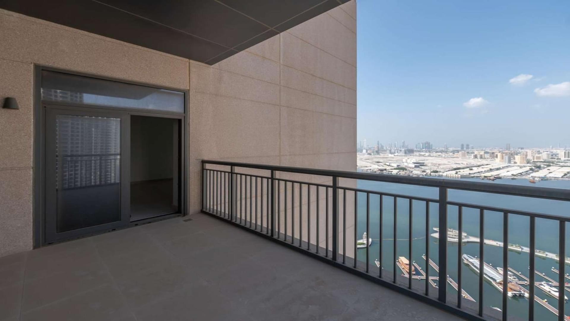 Spacious living room with large window in Dubai Creek Harbour apartment for rent