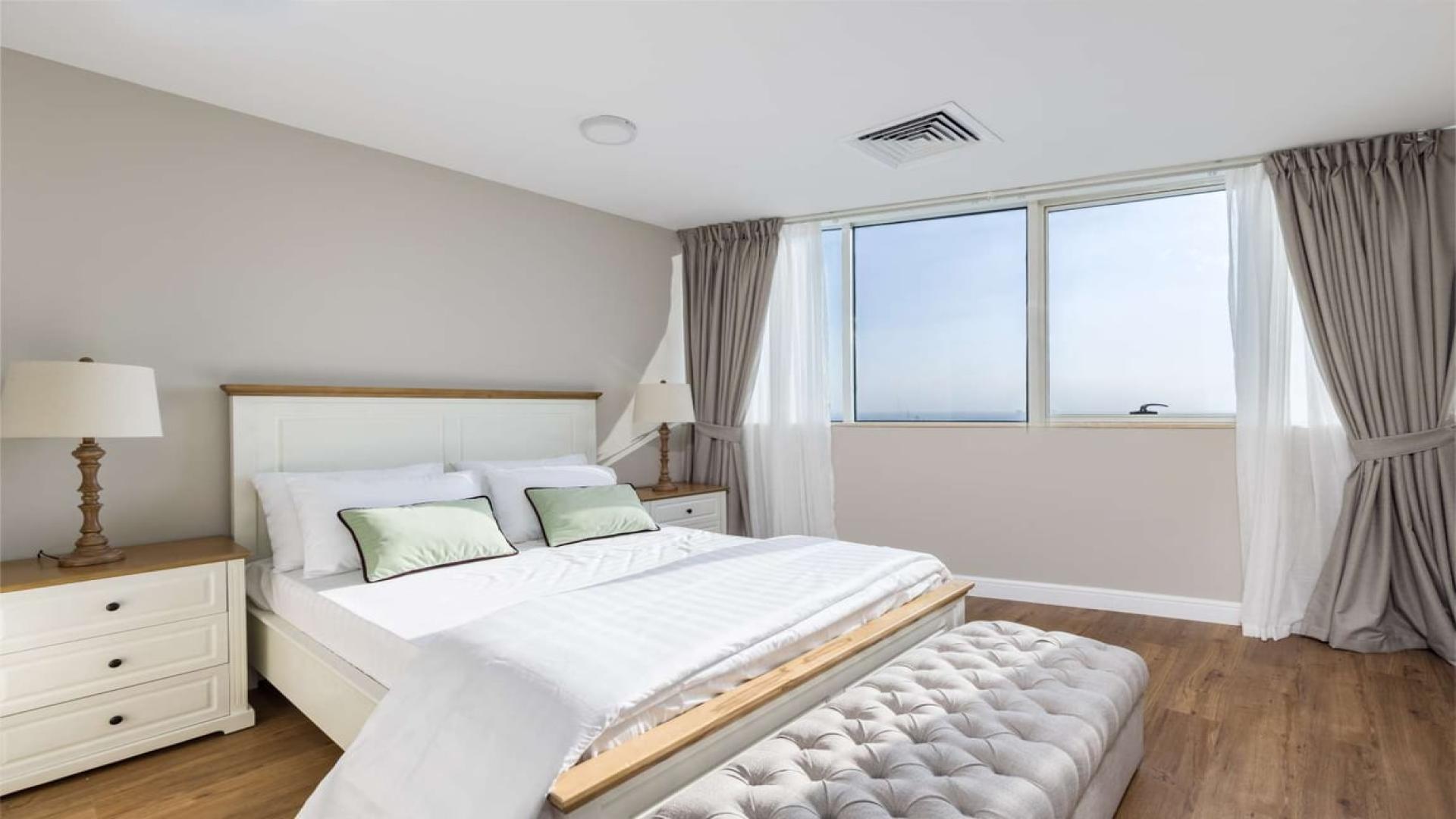 "Spacious living room in upgraded 4-bedroom apartment, Horizon Tower, Dubai Marina.",Bright bedroom in upgraded 4-bedroom apartment, Horizon Tower, Dubai Marina, with modern furnishings