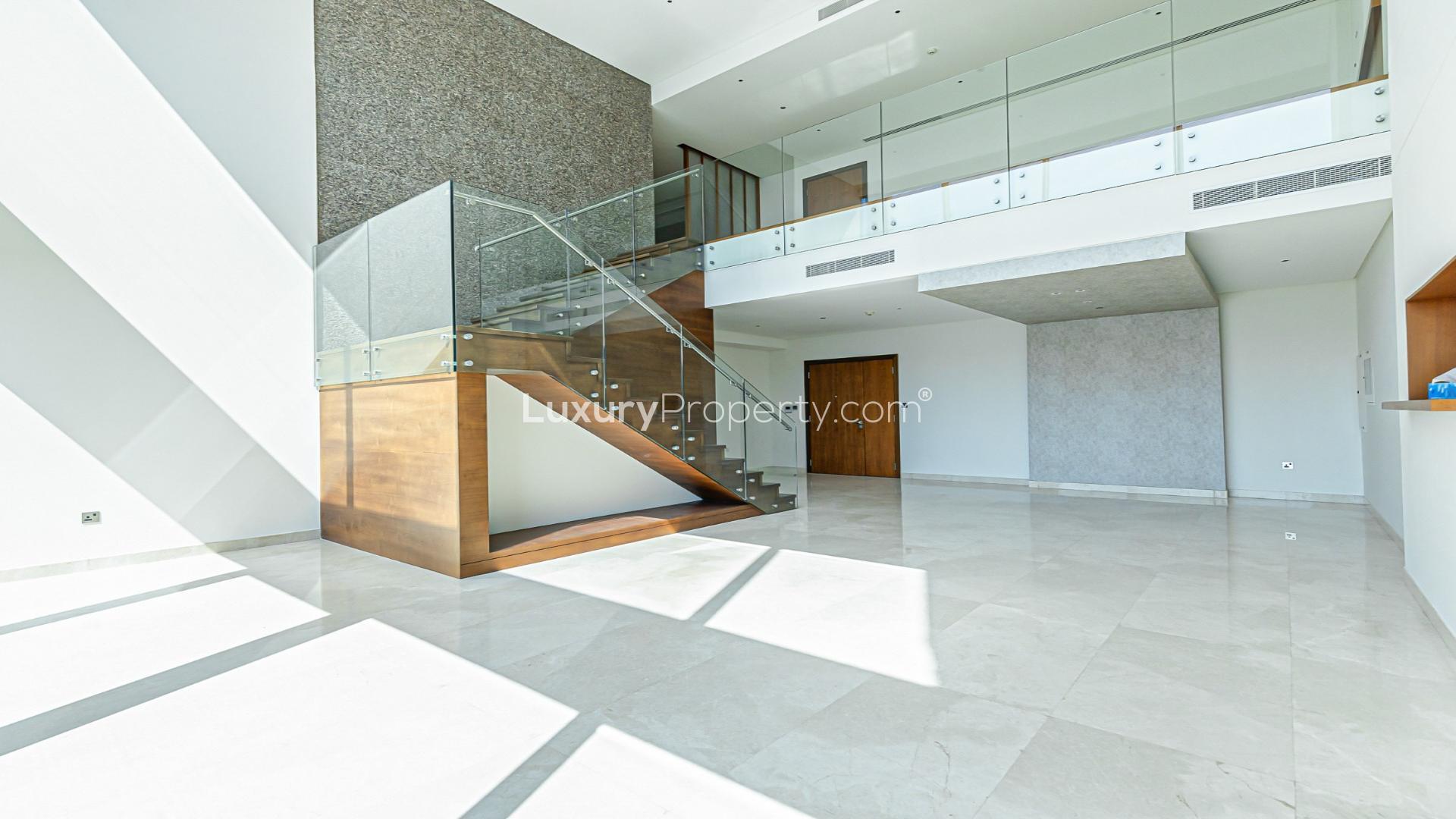 "Stunning balcony view from 4-bedroom duplex at Marina Gate 1, Dubai Marina for rent.",Spacious duplex living room with modern staircase in Marina Gate, Dubai Marina apartment